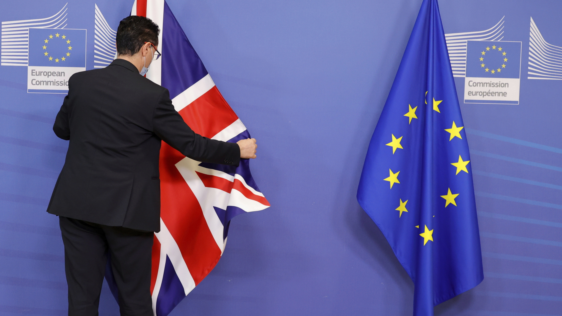 Ein Mitglied des Protokolls richtet die EU- und Fahne Großbritanniens. | dpa