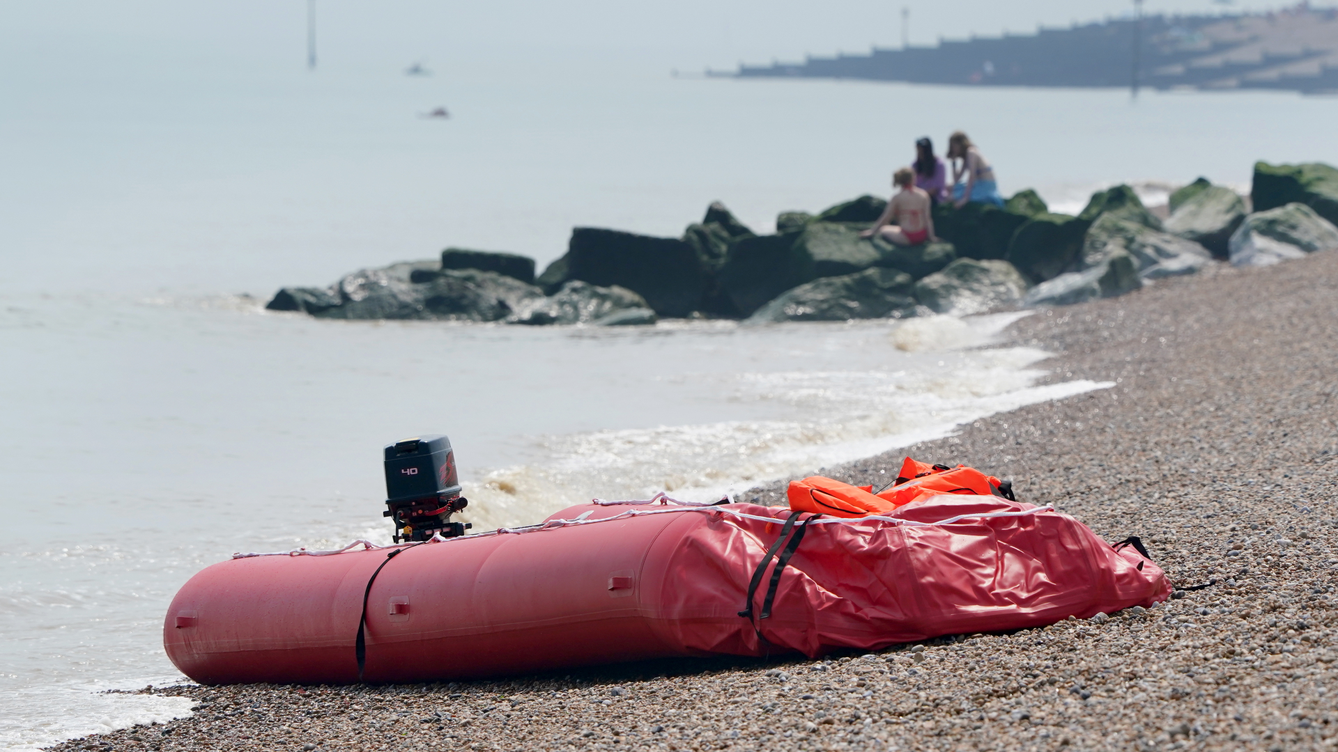 Ein Schlauchboot, mit dem vermutlich Migranten über den Ärmelkanal gekommen sind, liegt am Strand in Großbritannien. | dpa