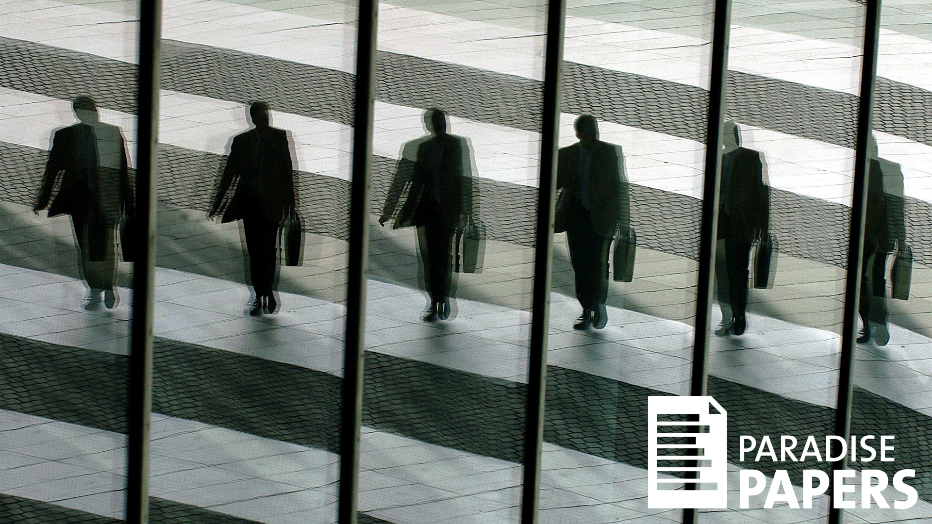 Mann mit einer Aktentasche spiegelt sich mehrmals in einer Glasfassade | picture alliance / dpa