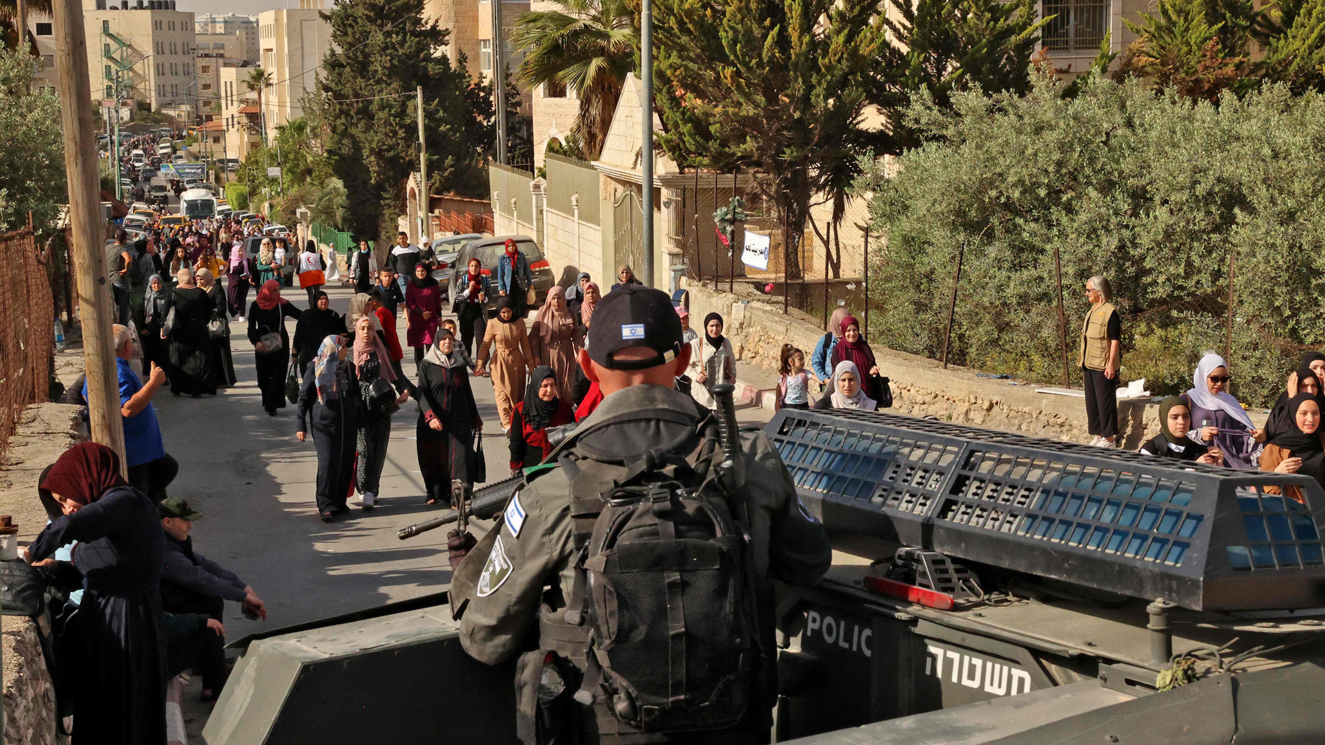 Israelische Sicherheitskräfte beobachten, wie Palästinenser einen Kontrollpunkt nach Jerusalem überqueren. | AFP