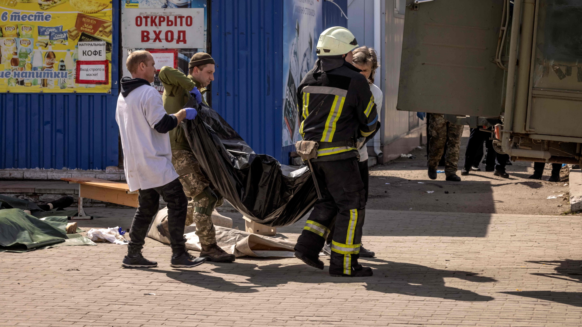 Helfer tragen einen Leichensack nach dem Raketenangriff auf den Bahnhof Kramatorsk. | AFP