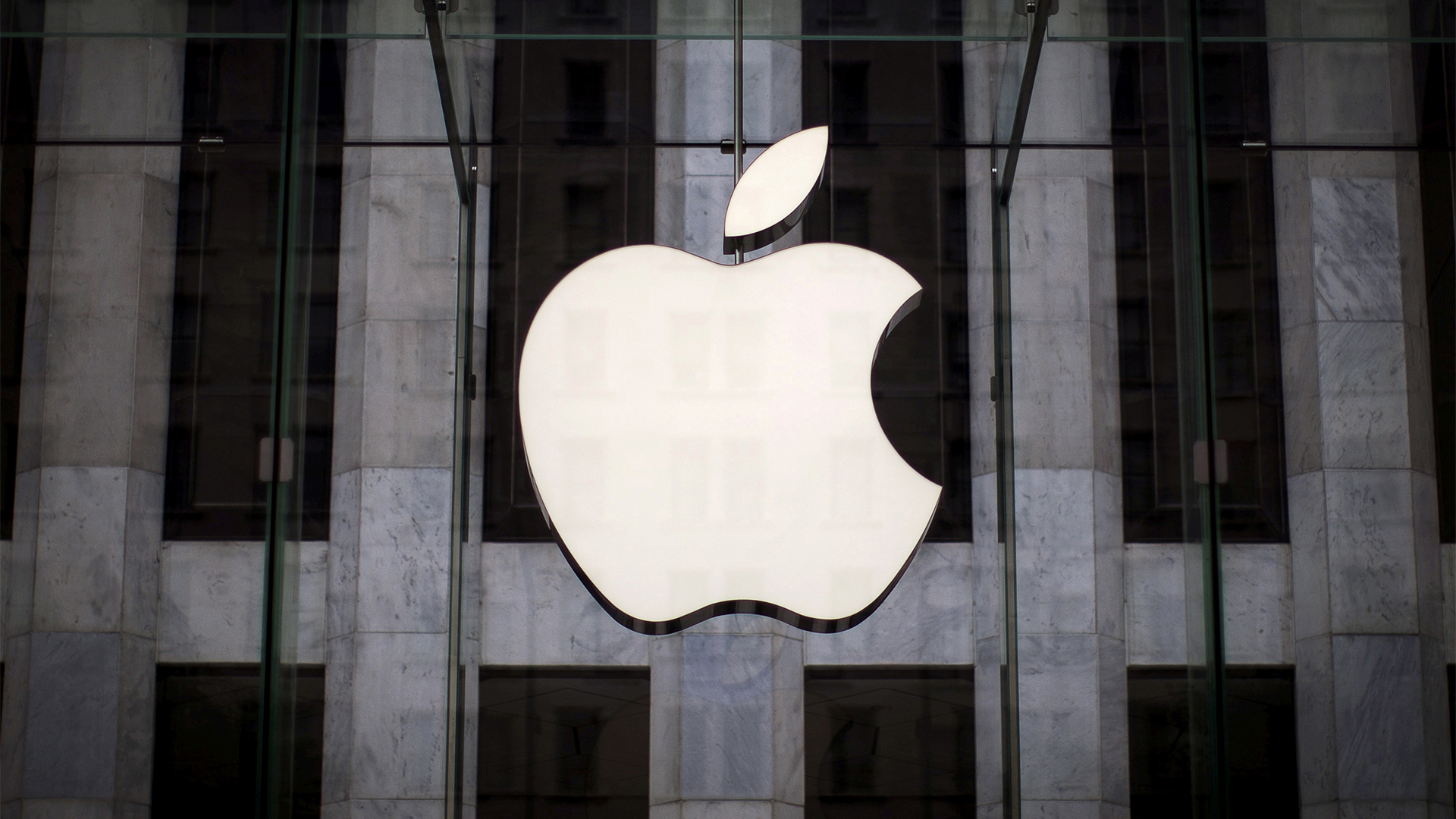 Ein Apple-Logo hängt über dem Eingang eines Apple Stores | REUTERS