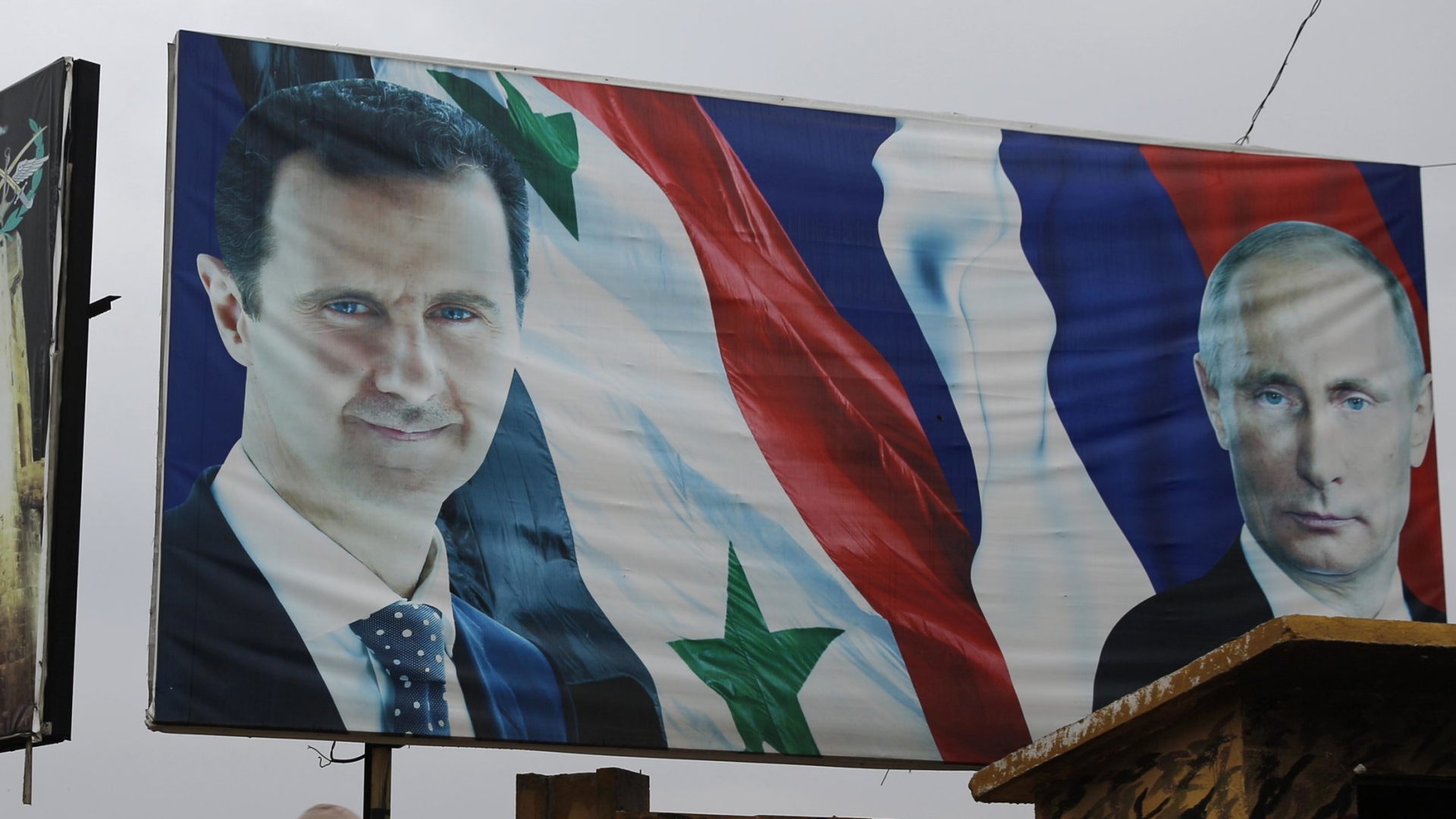 Ein Plakat in Aleppo zeigt den syrischen Präsidenten Assad und Russlands Präsidenten Putin.