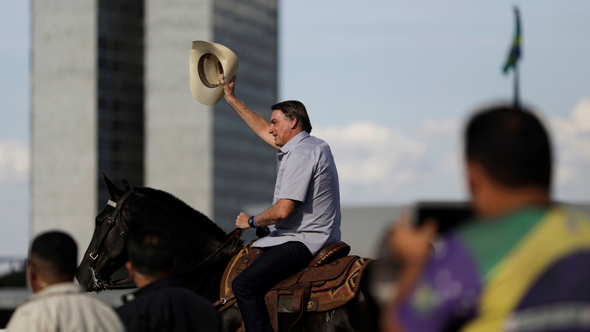 Brasiliens Präsident Bolsonaro schwenkt in Brasilia auf einem Pferd seinen Hut und grüßt Teilnehmer an einer Kundgebung gegen das Oberste Gericht und für ihn teil.
