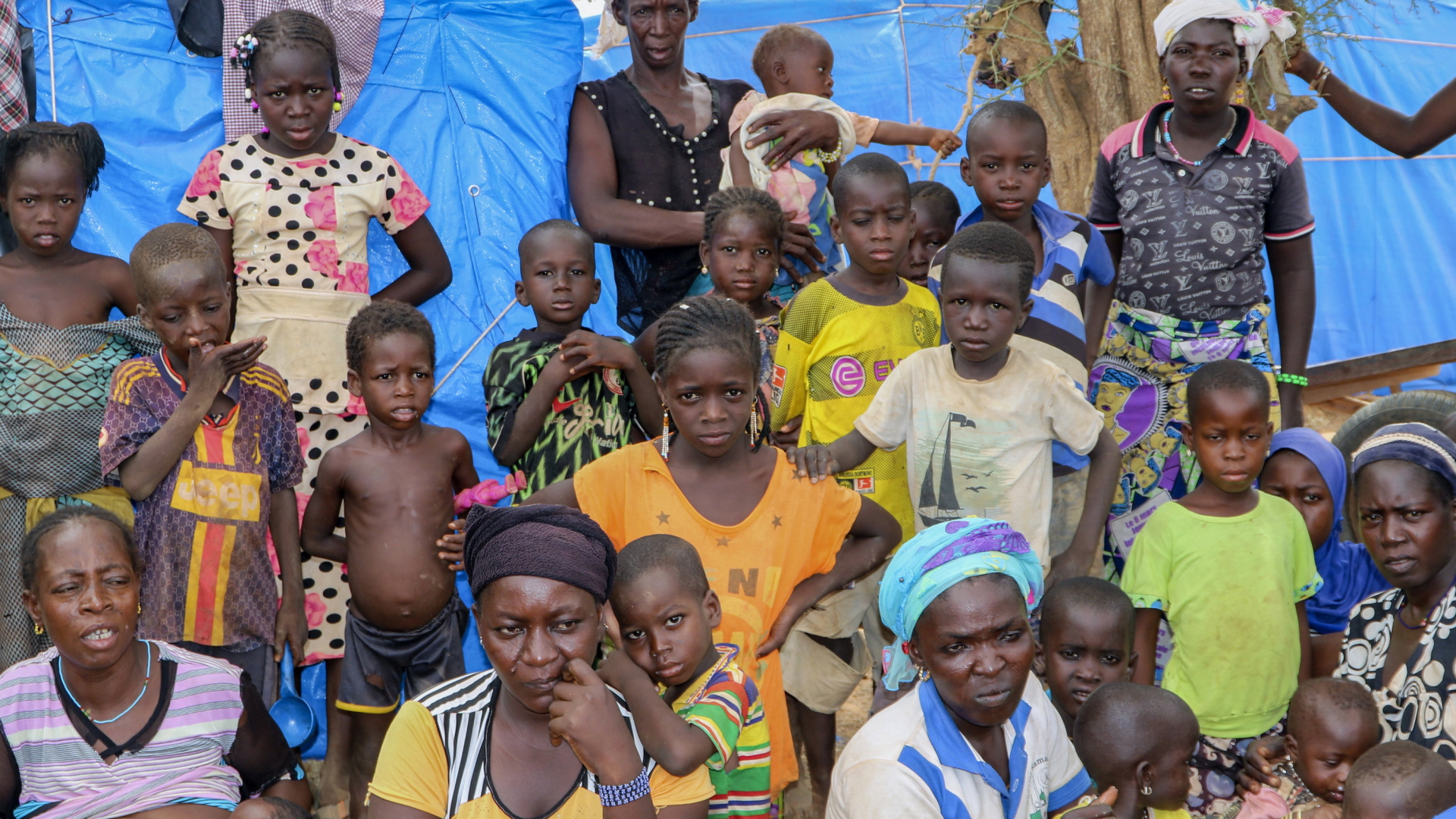 Geflüchtete Frauen und Kinder sitzen in Kongoussi, Burkina Faso, vor einem Zelt. | AP