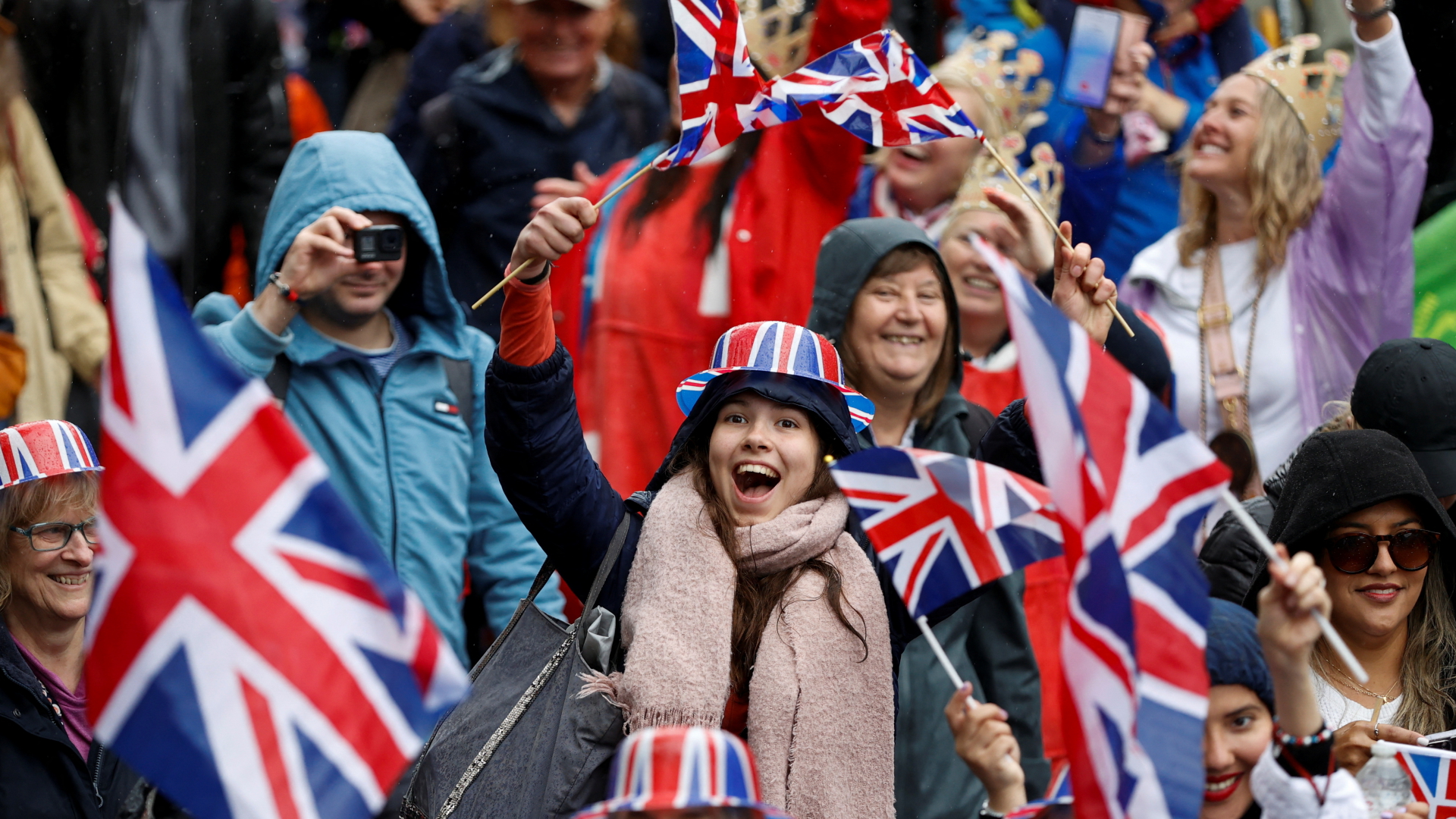 Menschen schwenken in London anlässlich der Krönung von Charles III. freudig britische Flaggen.