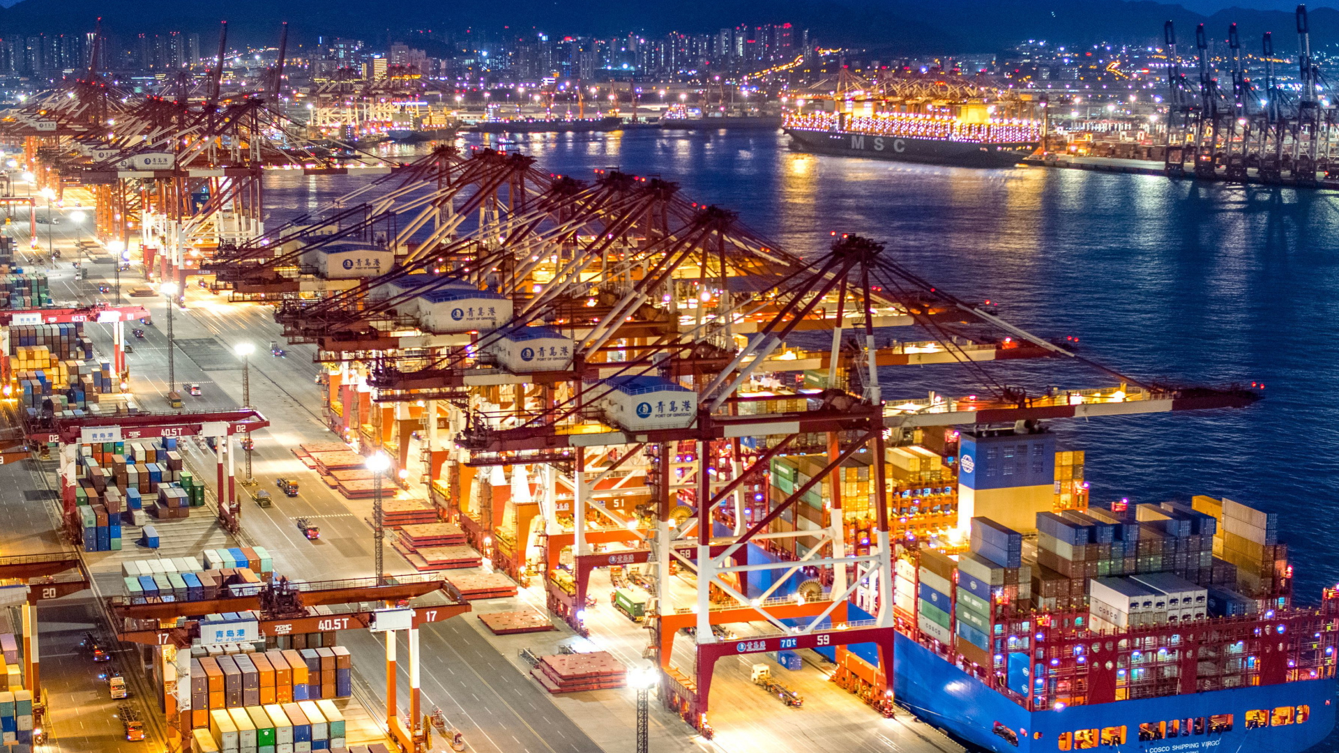 Containerschiffe liegen im nächtlich beleuchteten Containerterminal des Hafens von Qingdao (Archivbild von 2019) | dpa