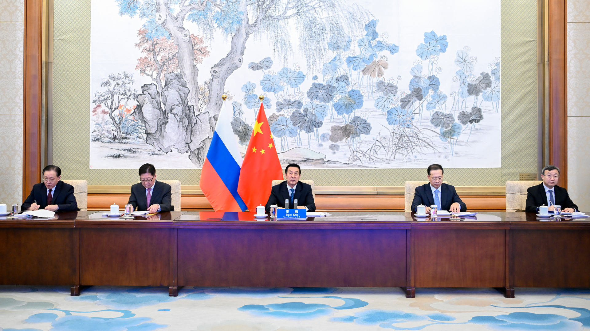 Wang Yong und eine Delegation vor Chinas und Russlands Staatsflaggen. | picture alliance / Xinhua News A