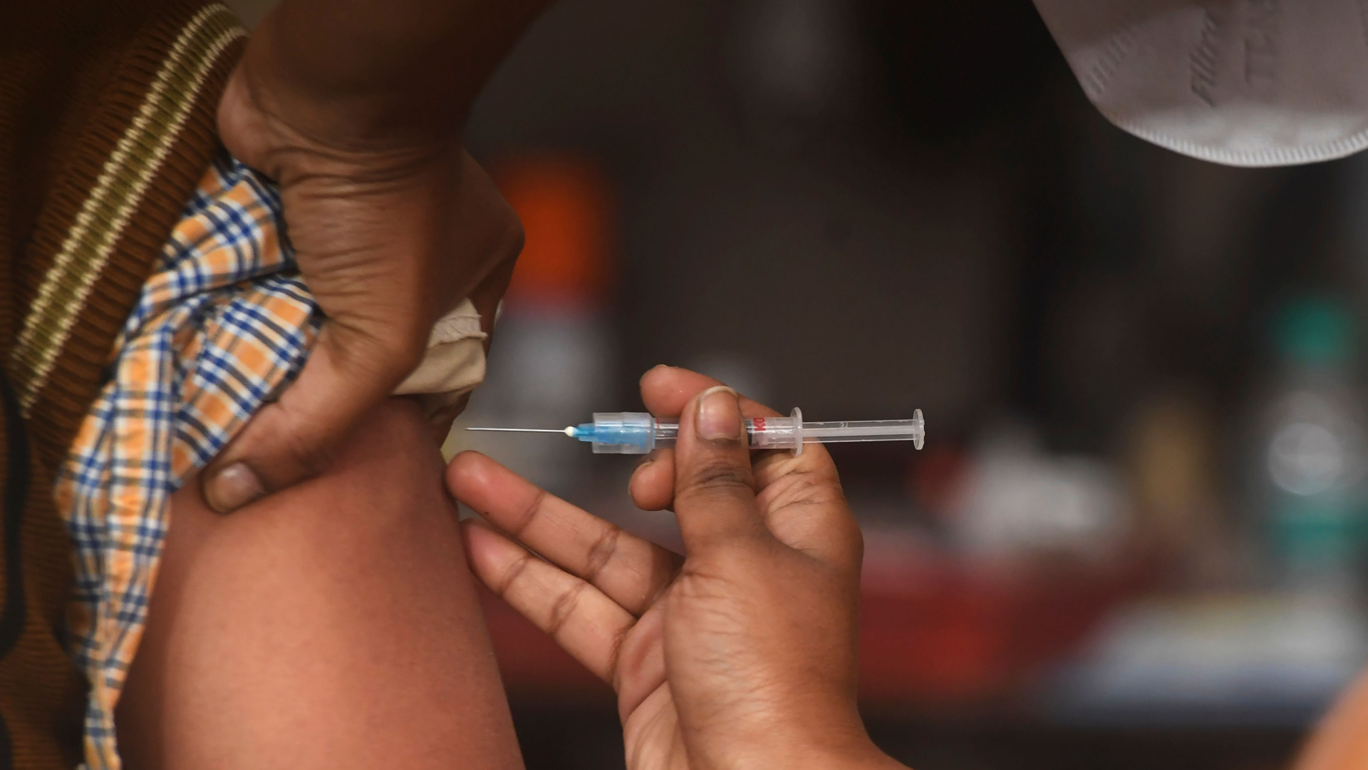 Eine Person im indischen Kalkutta wird gegen Corona geimpft.