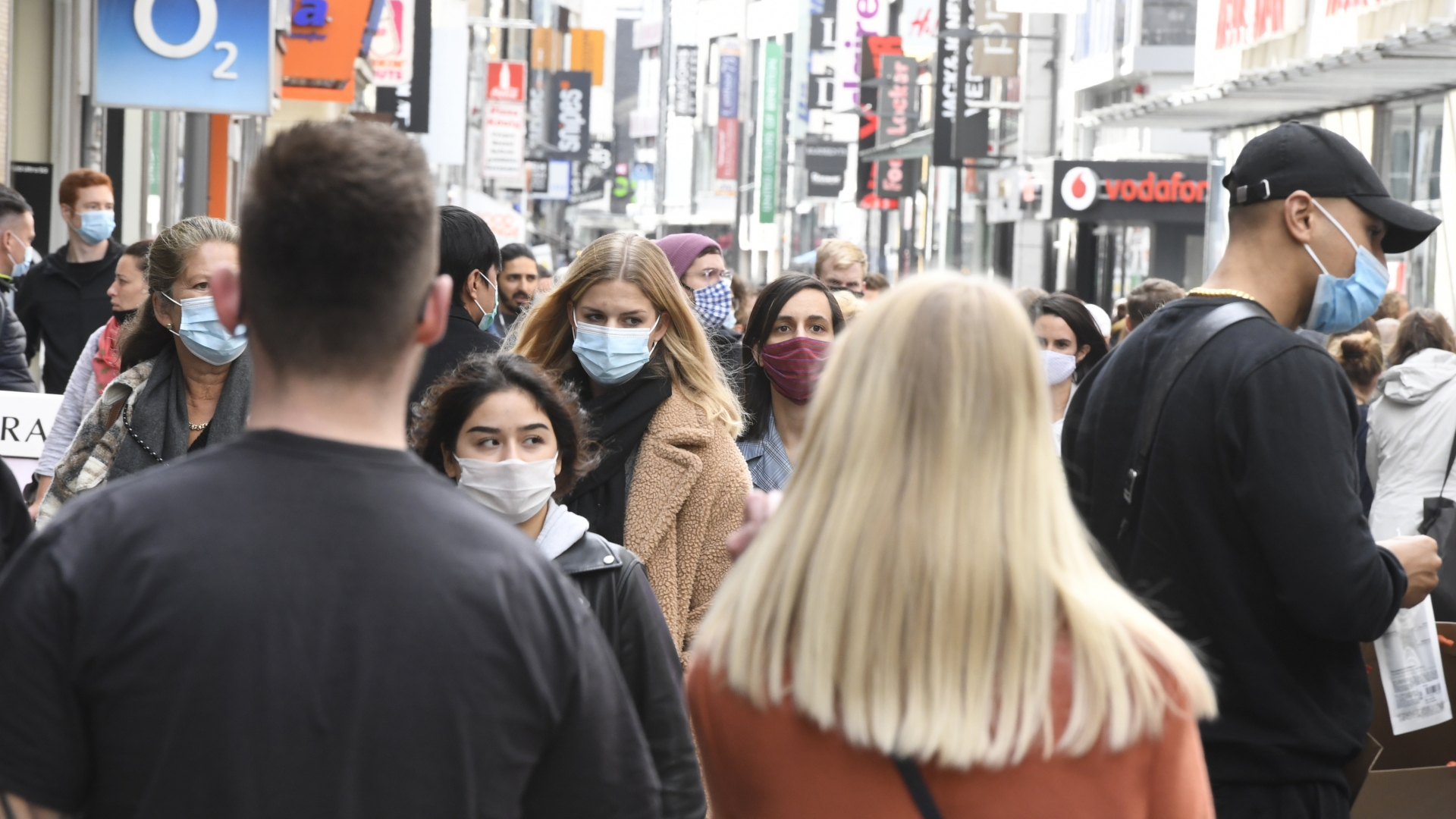 Passanten mit Gesichtsmasken in einer Fußgängerzone in Köln | dpa