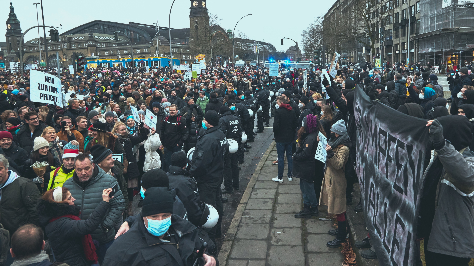 Polizisten bilden einen Schutz zwischen Teilnehmern einer Demonstration gegen die Corona-Maßnahmen und Gegendemonstranten in Hamburg. | dpa