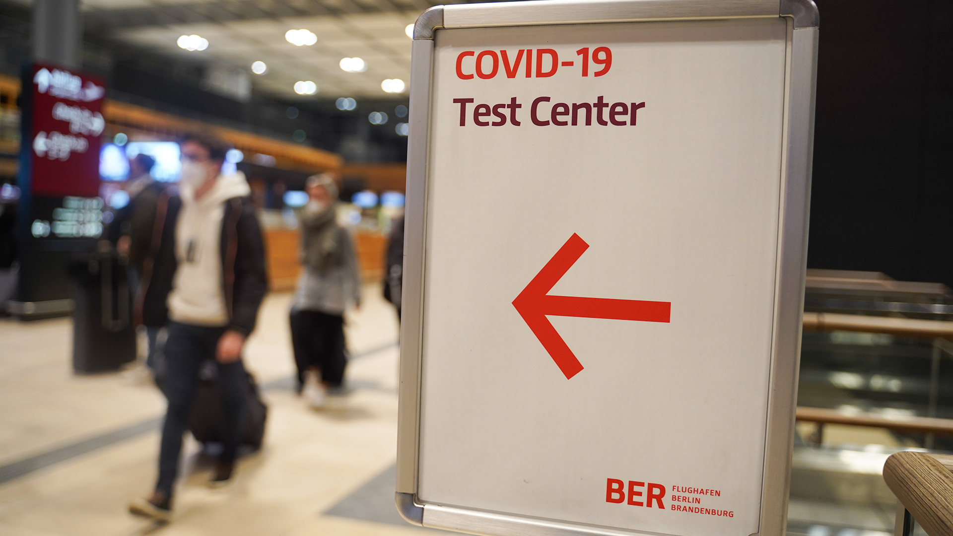 Ein Schild weist am Flughafen BER zum Corona-Testzentrum. | dpa