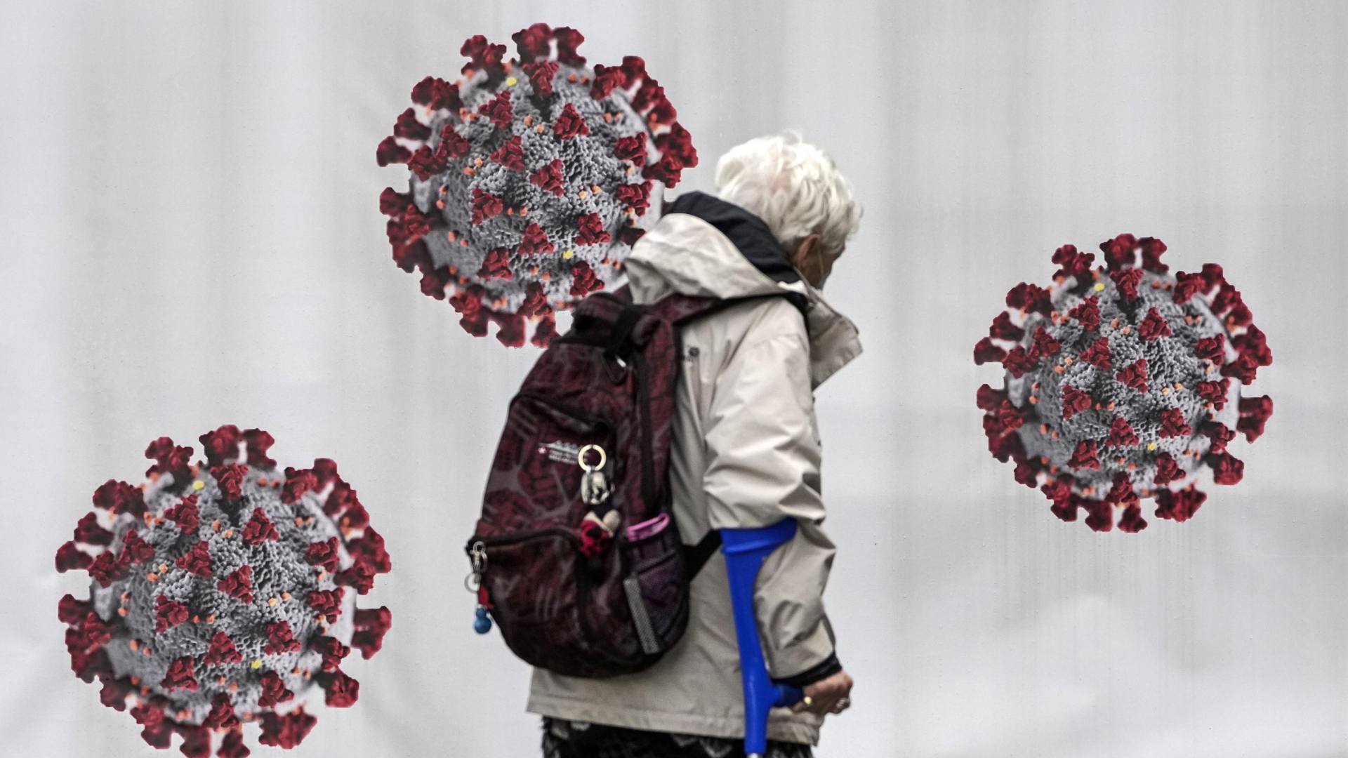 A woman passes a coronavirus test center in Duisburg, Germany, Tuesday, Oct. 12, 2021.  | AP