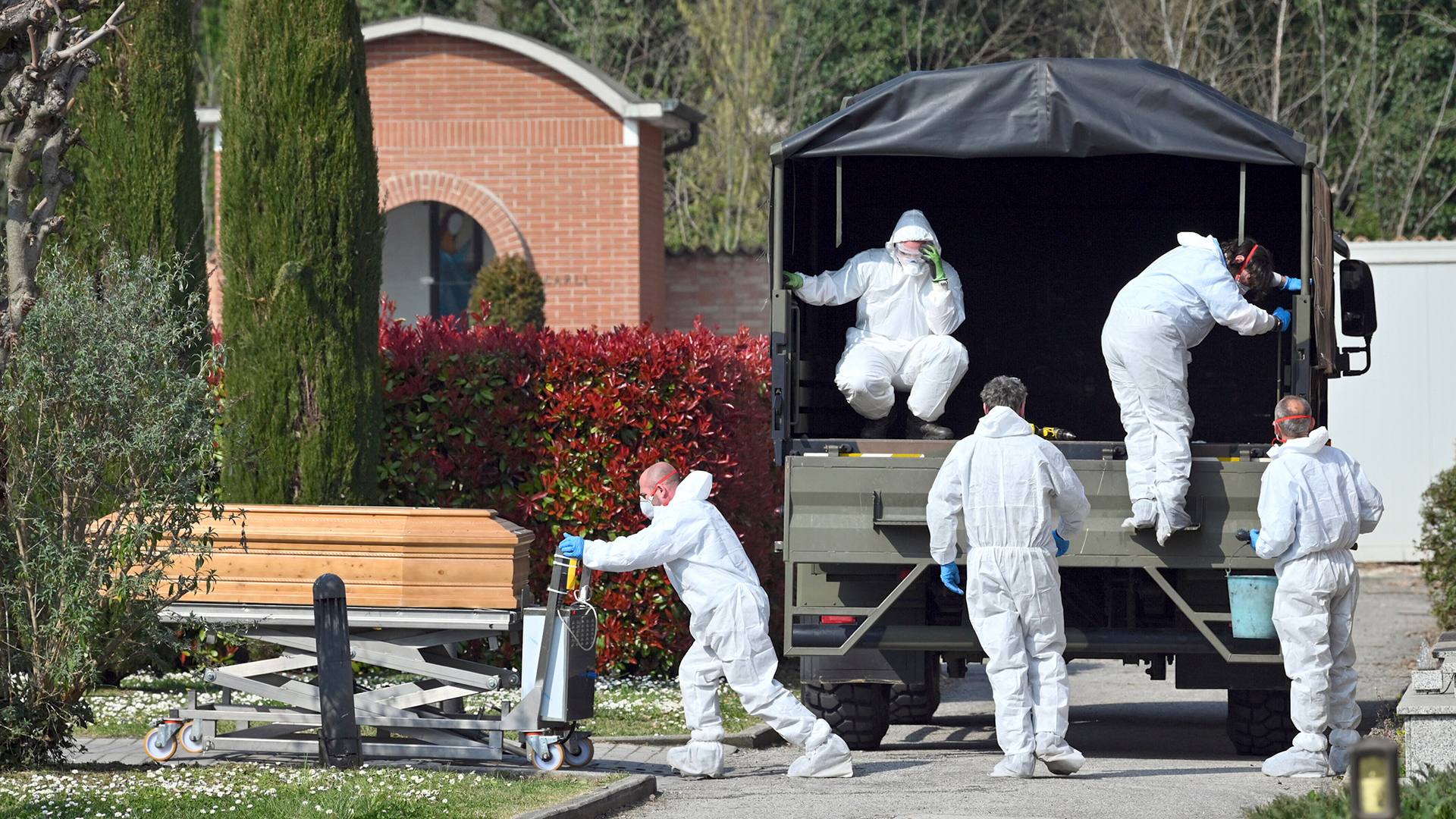 Ein Konvoi italienischer Armeelastwagen wird bei der Ankunft aus Bergamo entladen und bringt Leichen von Coronavirus-Opfern auf den Friedhof von Ferrara, Italien, wo sie eingeäschert werden.