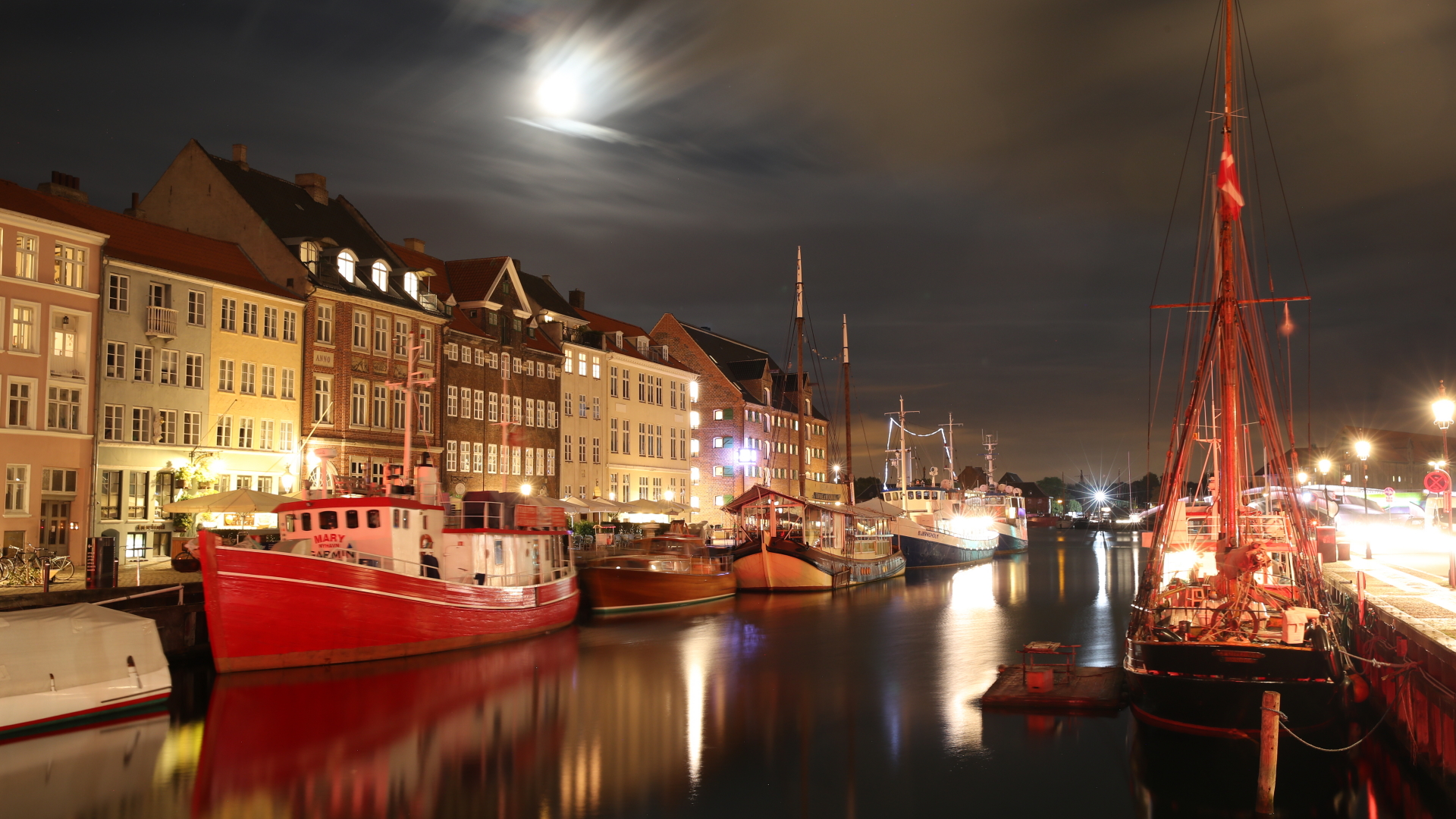 Eine abendliche Straße an einem Kanal im Kopenhagener Stadtteil Nyhavn. | dpa