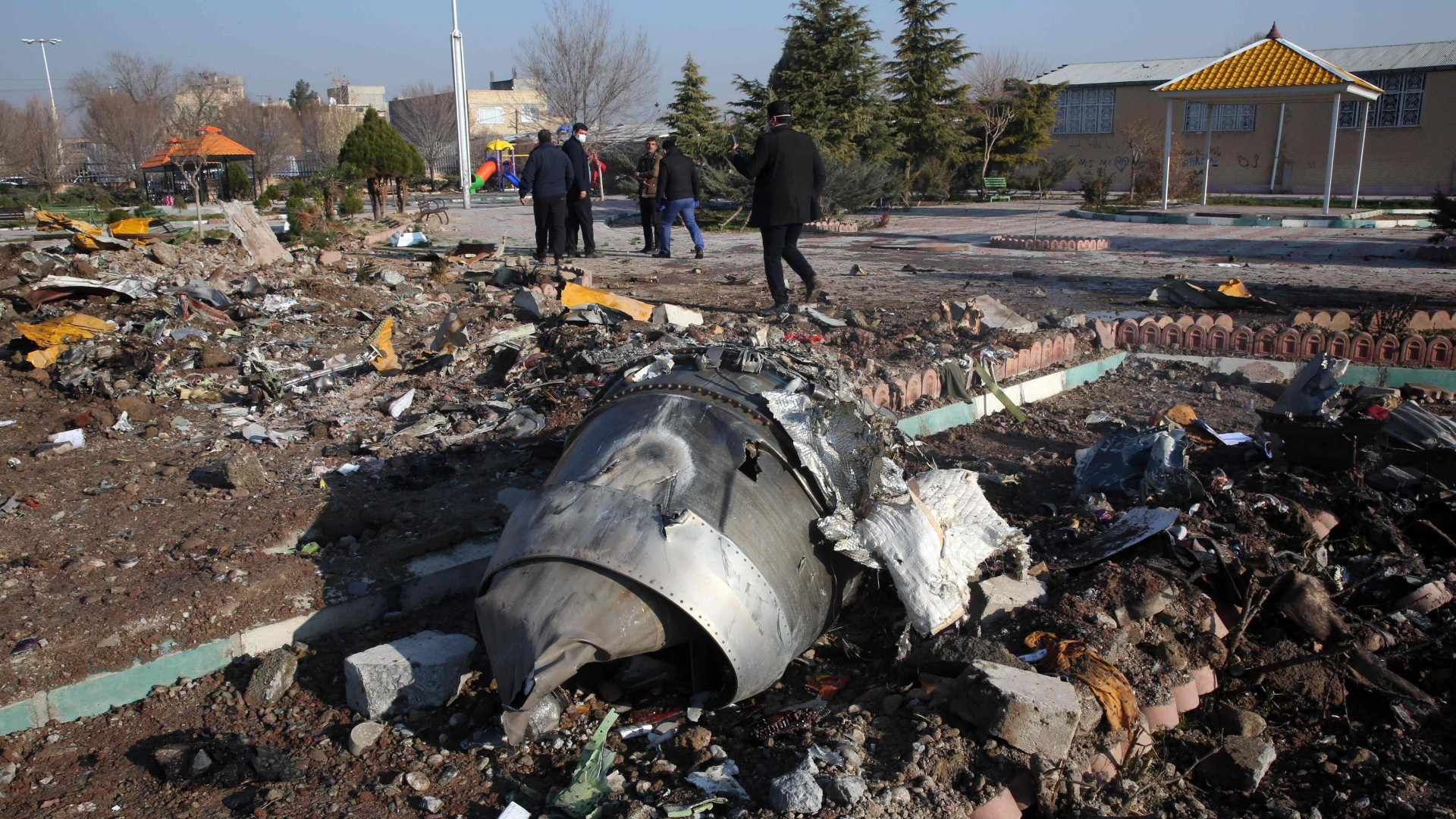 Trümmerteile der abgestürzten Boeing 737 liegen auf einem Feld nahe Teheran. | AFP