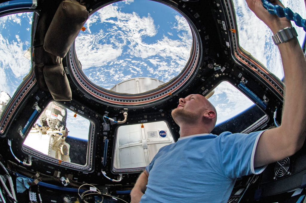 Astronaut Alexander Gerst am 12.06.2014 blickt durch ein Fenster in der ISS in den Weltraum