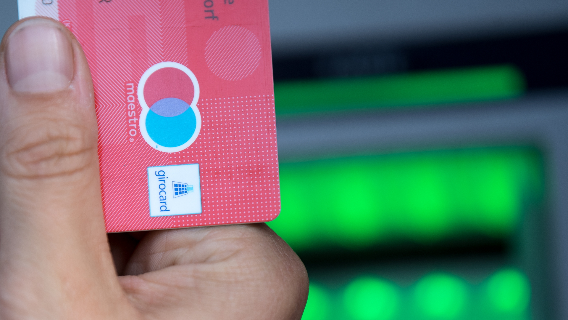 Eine Kundin steckt eine Girocard in einen Bankautomaten | dpa