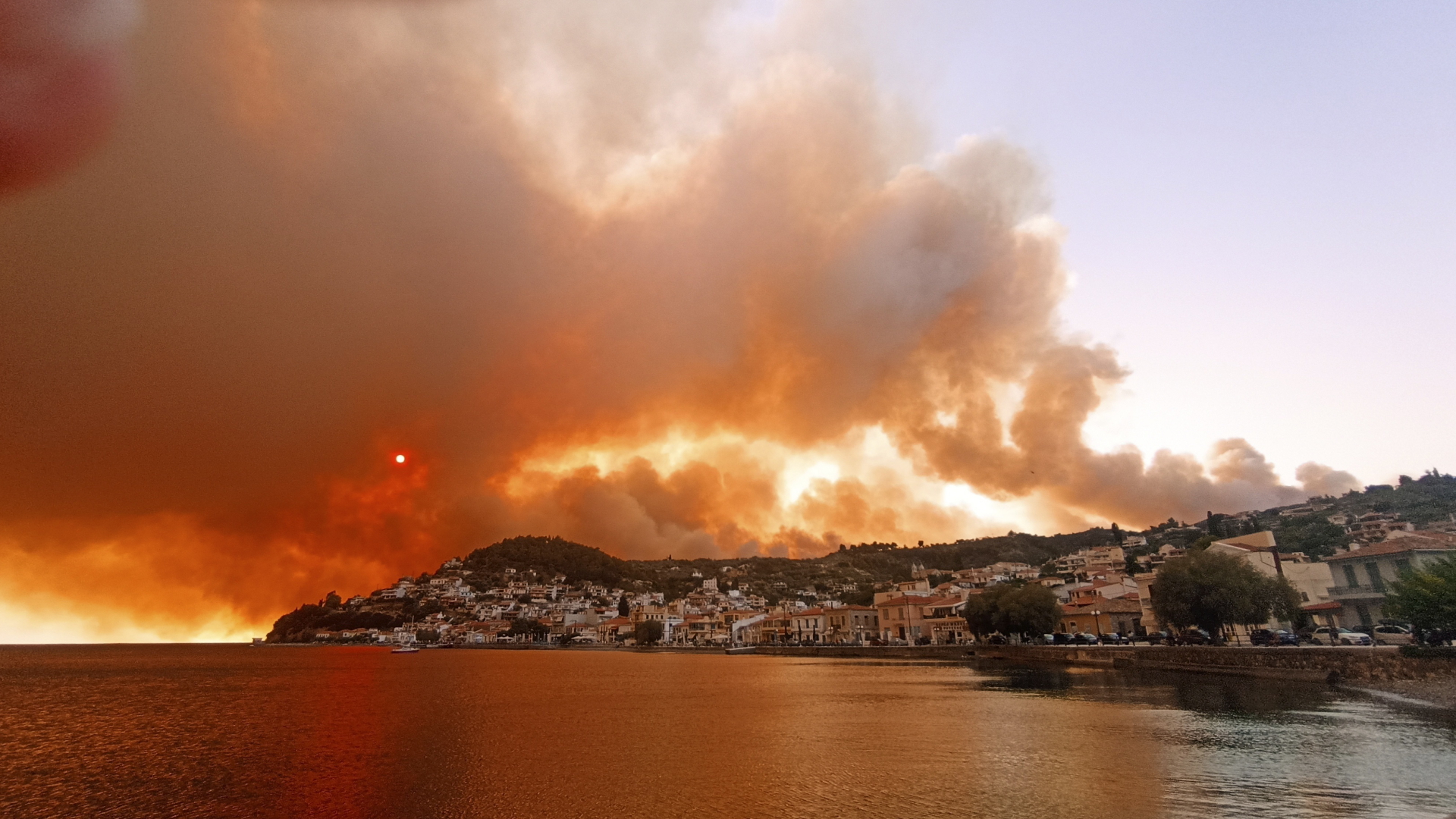 Rauch eines Waldbrandes steigt hinter einem Berghang auf der griechischen Halbinsel Euböa auf