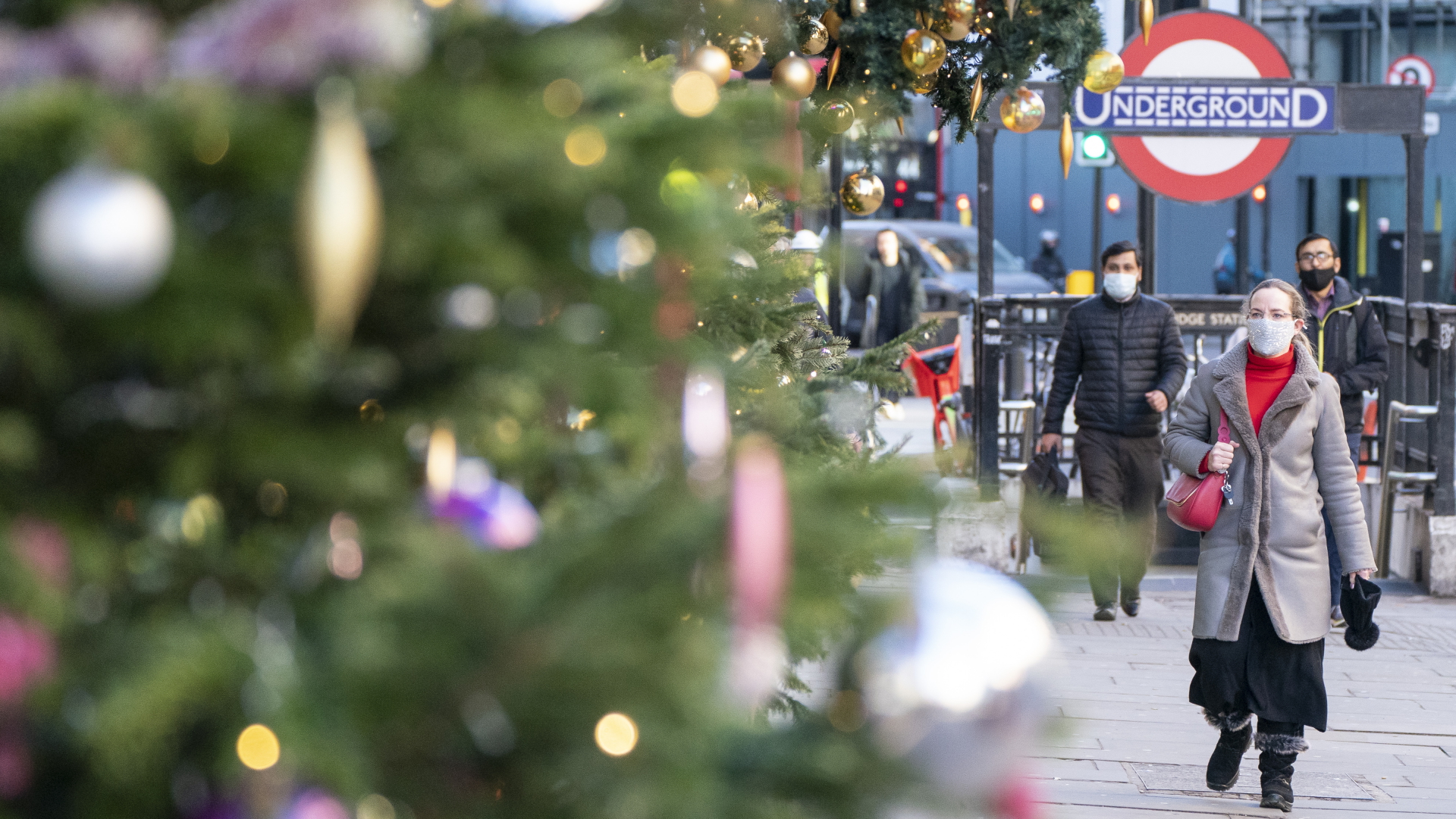 Fußgänger tragen Masken, während sie an der Weihnachtsdekoration in Knightsbridge vorbeigehen, einem der besten Wohn- und Geschäftsviertel der britischen Hauptstadt London. | dpa
