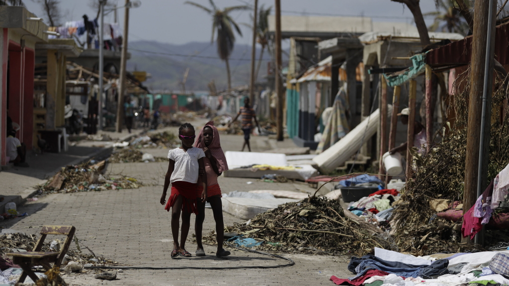 Kinder gehen in Les Anglais, Haiti, eine verwüstete Straße entlang. | AP