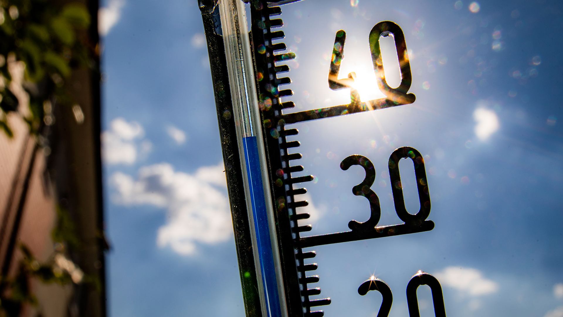  Ein Thermometer an einer Hauswand klettert in Richtung der 40-Grad-Marke. | dpa