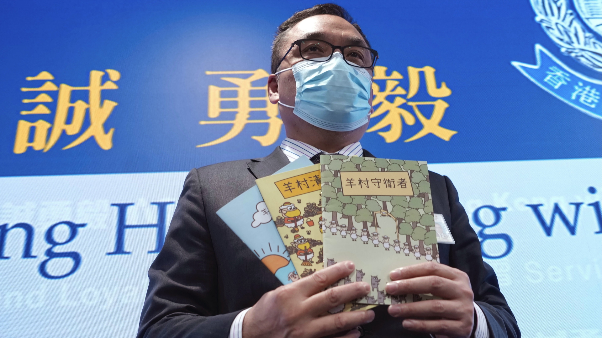Li Kwai-wah, leitender Beamter des Nationalen Sicherheitsministeriums der Polizei in Hongkong, posiert mit Beweisen, darunter drei Kinderbücher. | AP