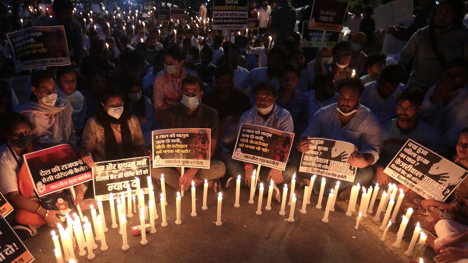 Menschen in Neu-Delhi haben Kerzen für das tote Mädchen angezündet und fordern auf Plakaten Gerechtigkeit. | EPA