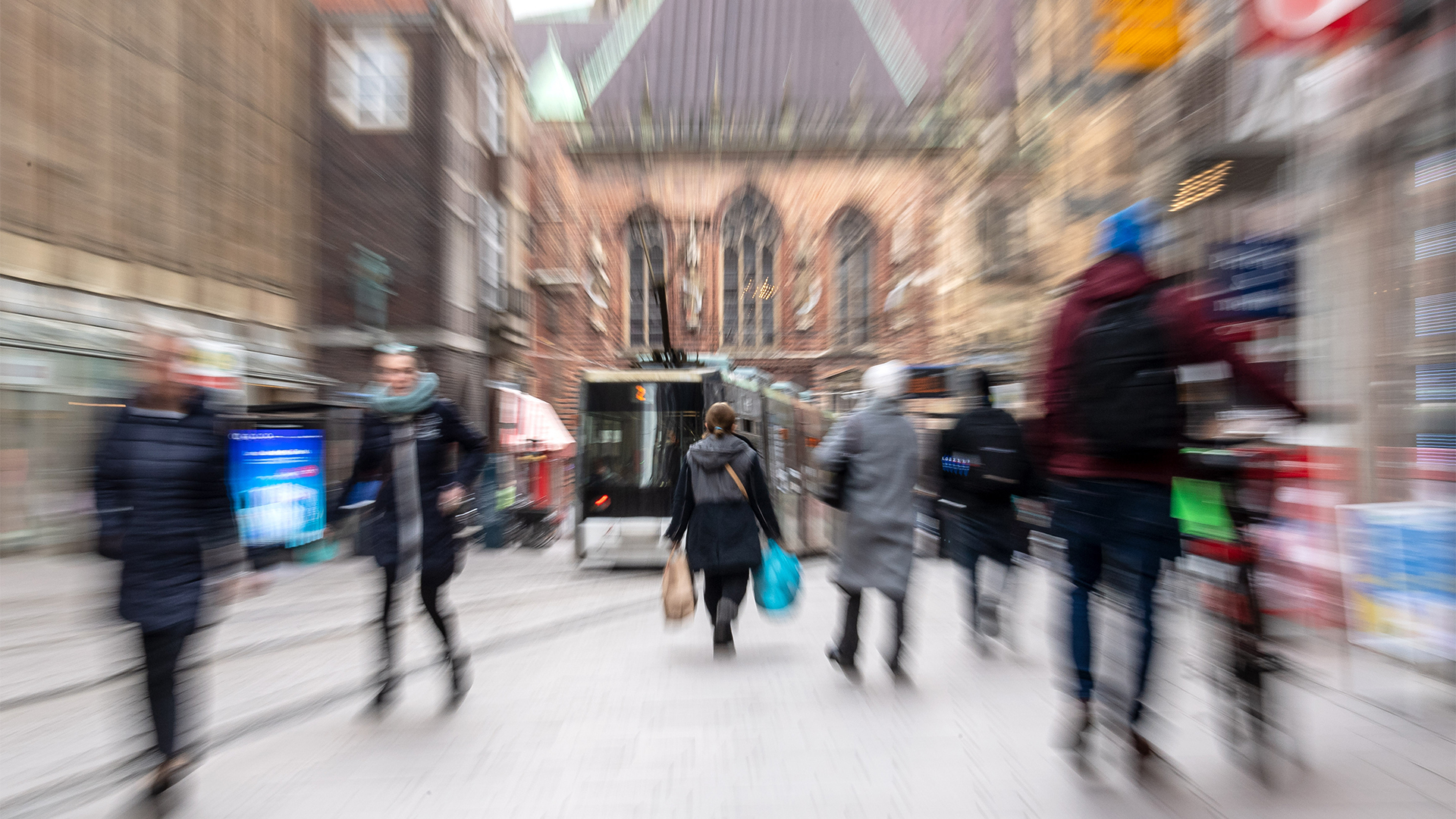 Passanten gehen durch eine Einkaufstraße in Bremen. | dpa