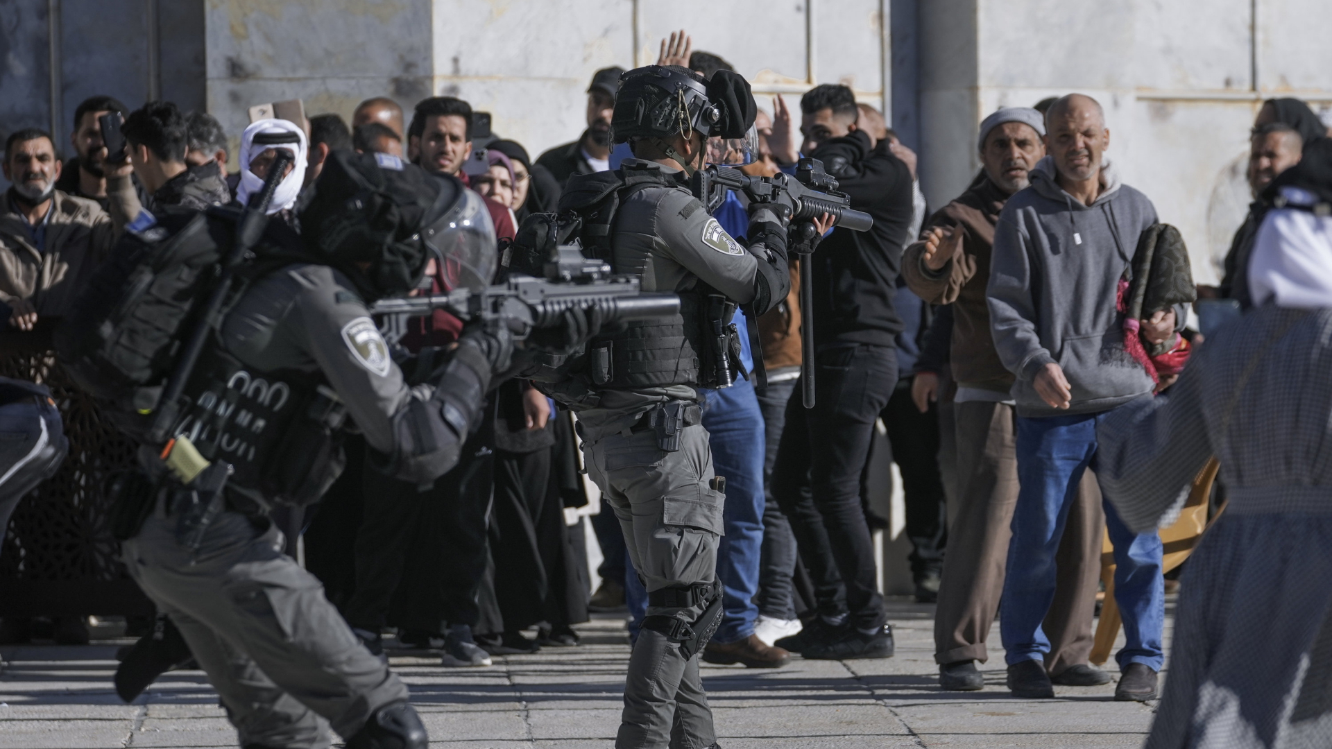 Israelische Polizisten versuchen palästinensische Muslime an der Al-Aksa-Moschee zu beschwichtigen. | AP