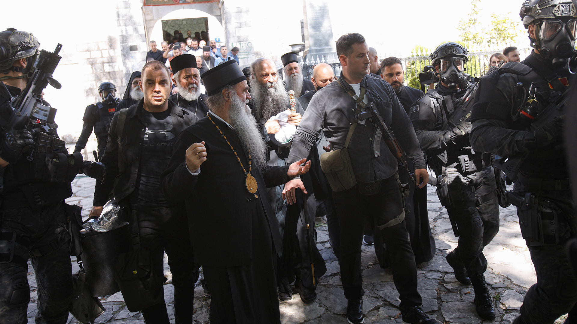 Sicherheitskräfte eskortieren Patriarch Portfirije und Bischof Joanikije vor dem Kloster in Cetinje, Montenegro. | REUTERS
