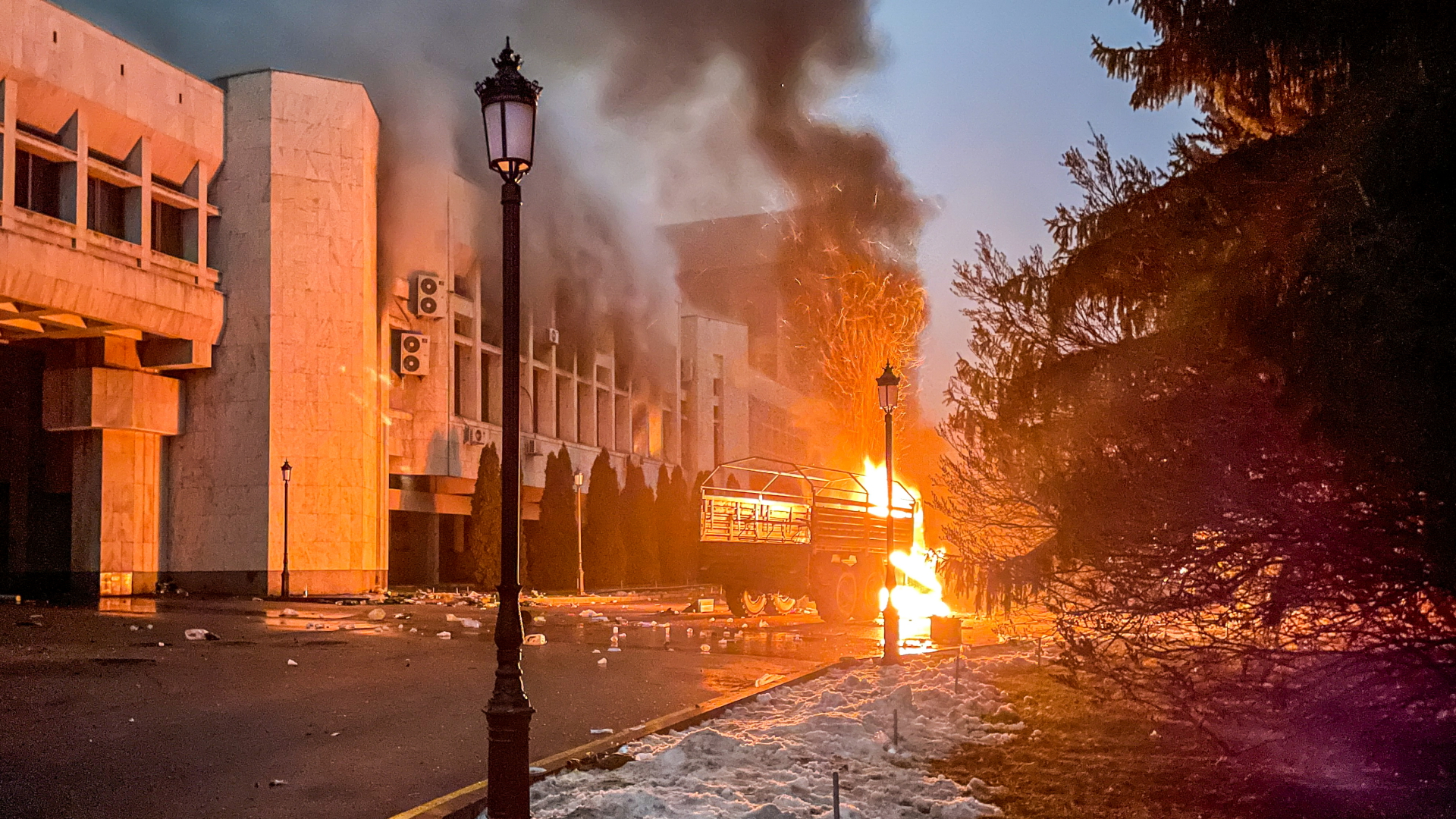 Das Bild der russischen Staatsagentur Tass zeigt das brennende Bürgermeisteramt von Almaty (Archivbild). | dpa