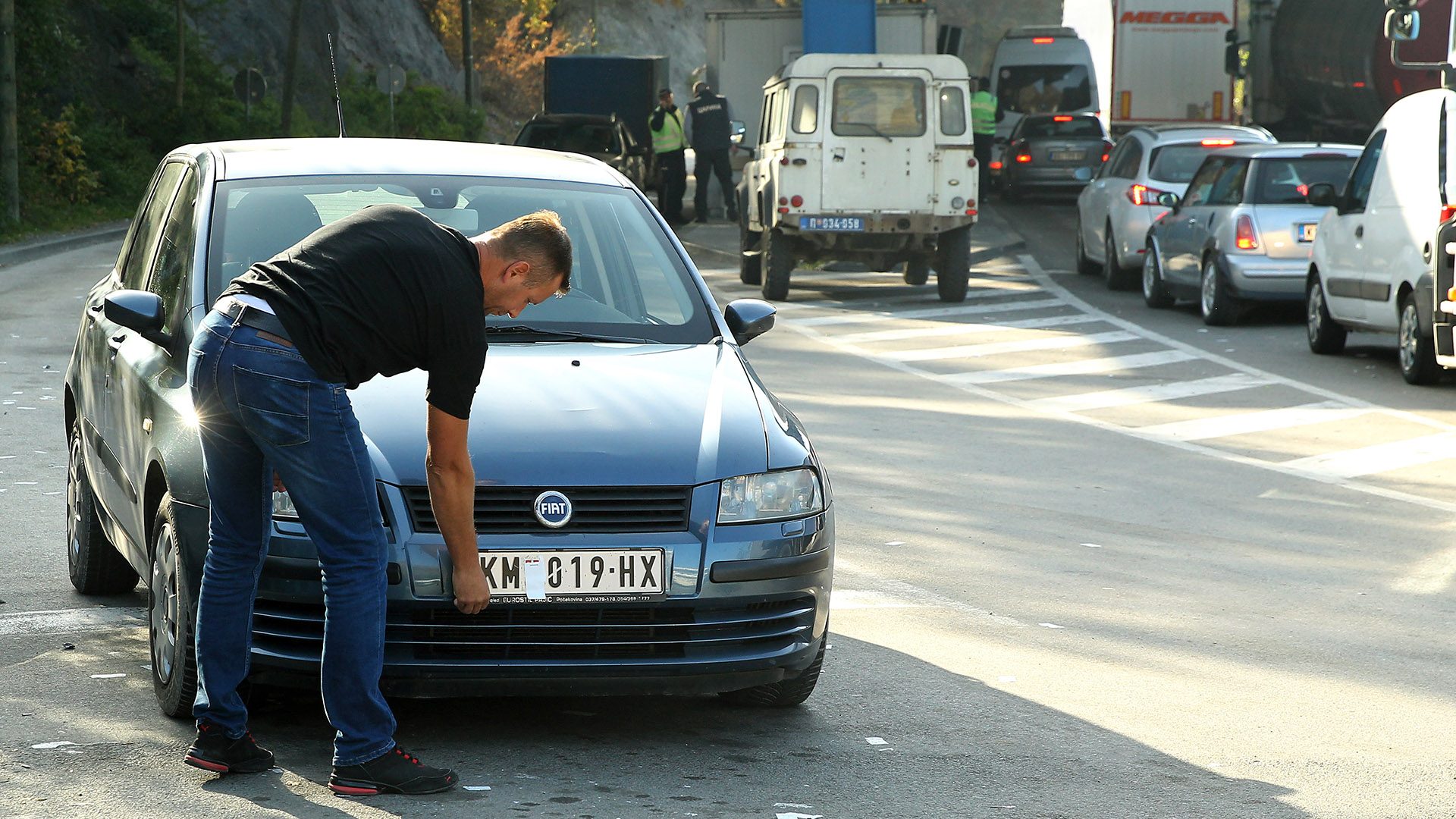 Autofahrer im Kosovo entfernt einen Aufkleber von seinem Kfz-Kennzeichen | EPA