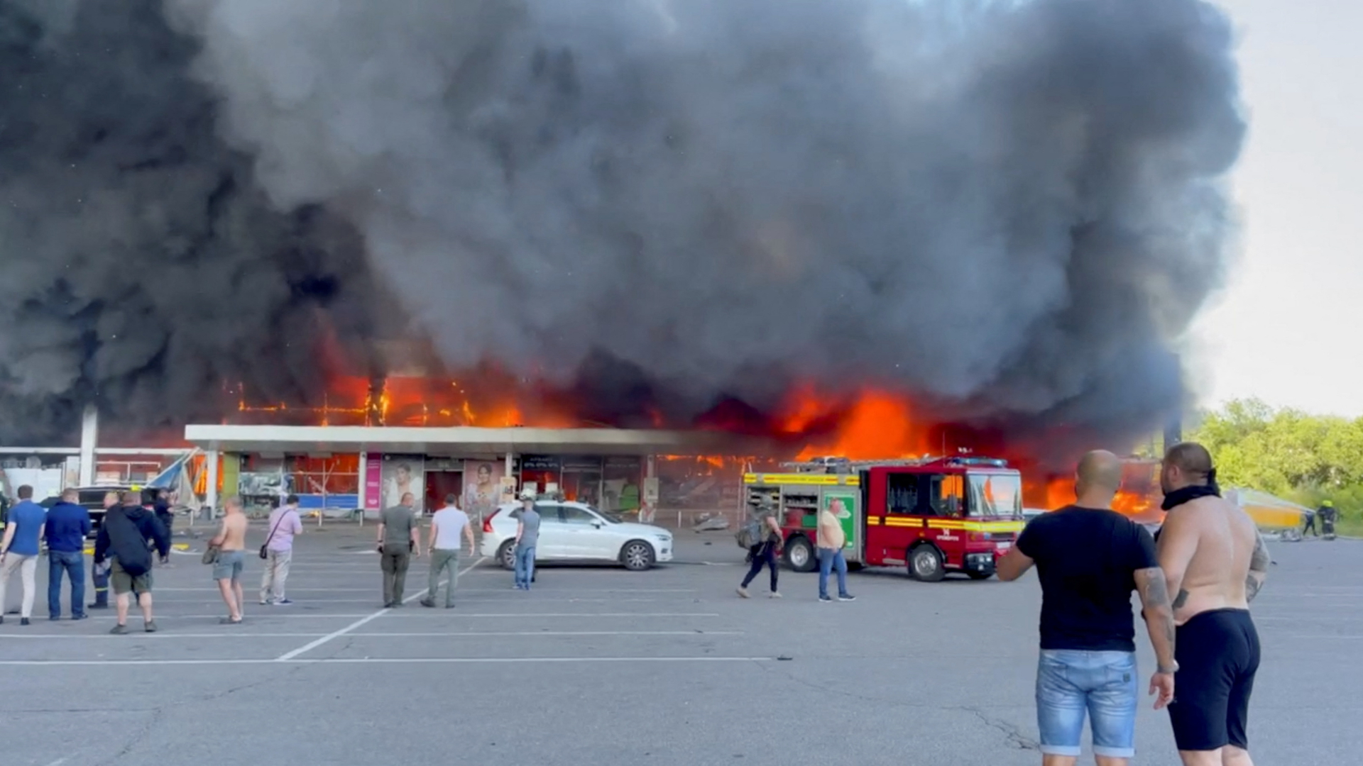 Menschen stehen vor dem brennenden Einkaufzentrum in Krementschuk | via REUTERS