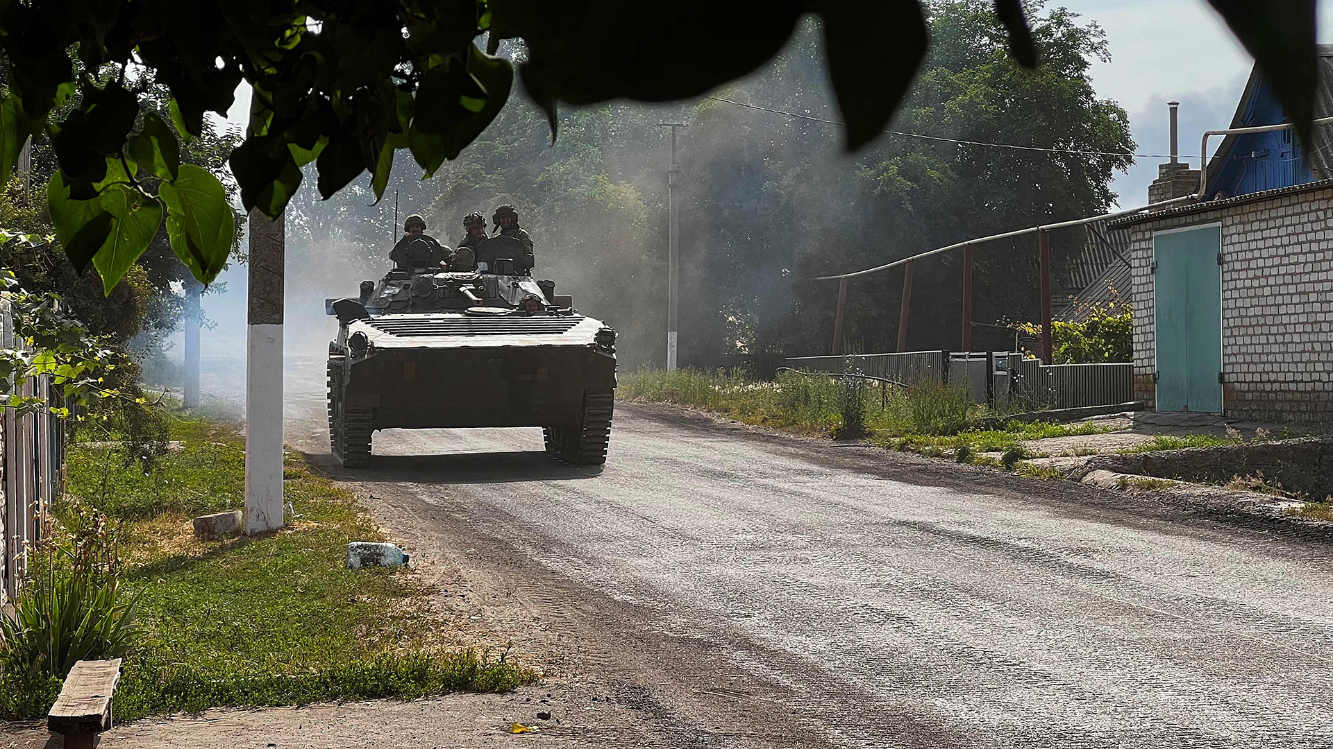 Ukrainische Soldaten fahren in einem gepanzerten Fahrzeug auf der Hauptstraße nach Lyssytschansk in der ostukrainischen Region Donbass.