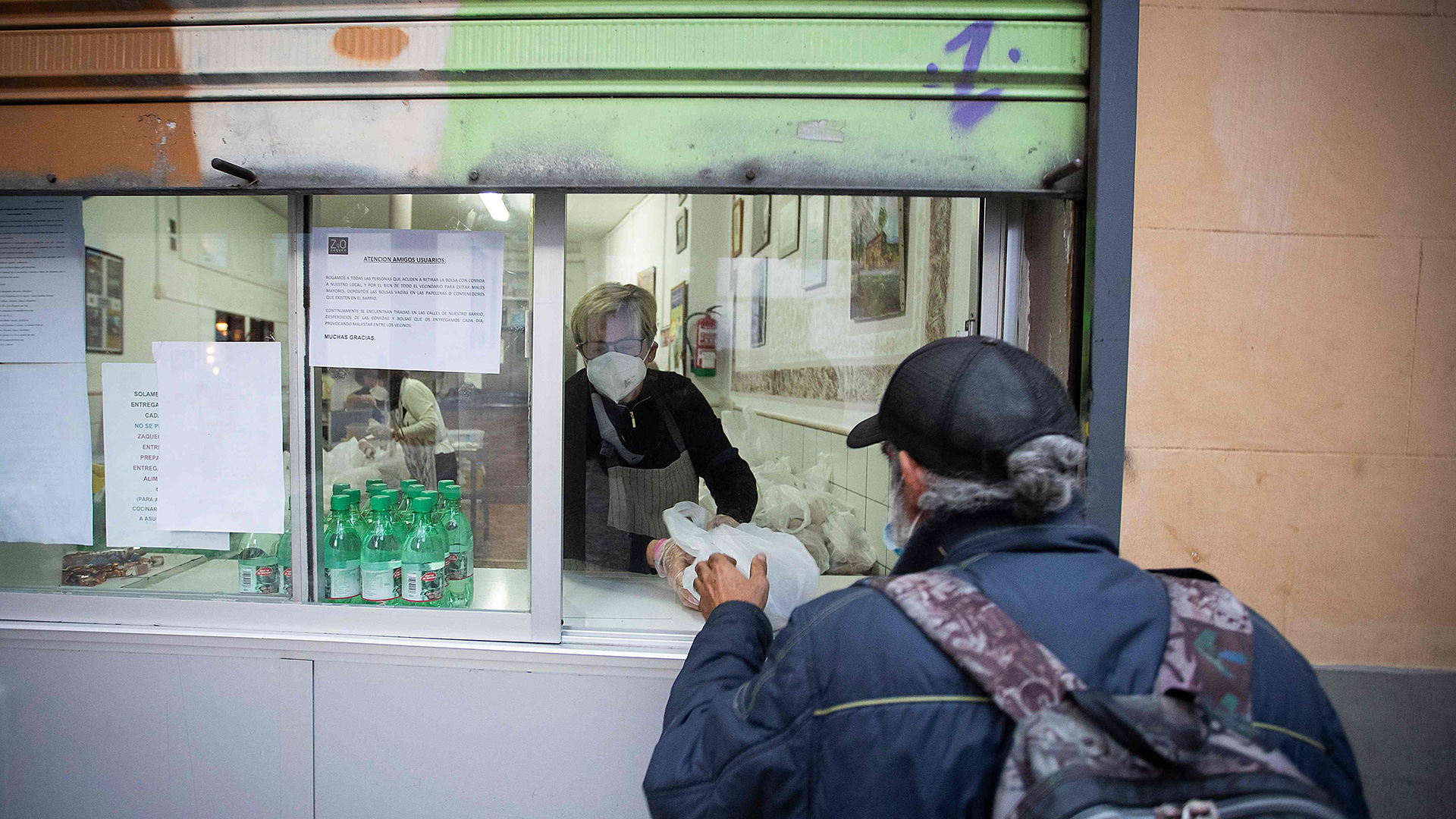 Ein Mann erhält eine Ration Lebensmittel bei der Zaqueo Association in Palma de Mallorca. | AFP
