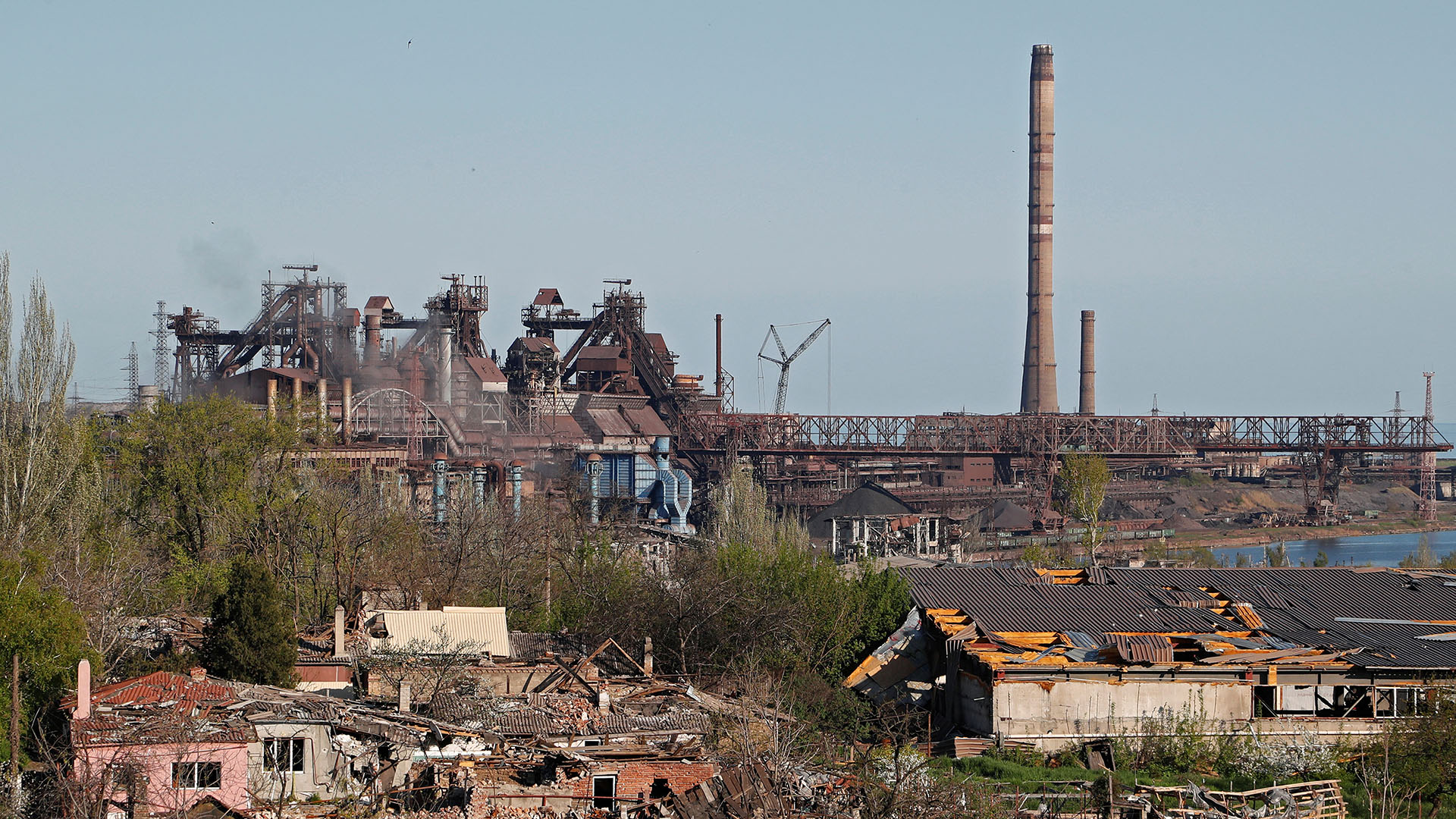 Das Stahlwerk Asowstal im Hintergrund und zerstörte Häuser in Mariupol (Archivbild) | REUTERS