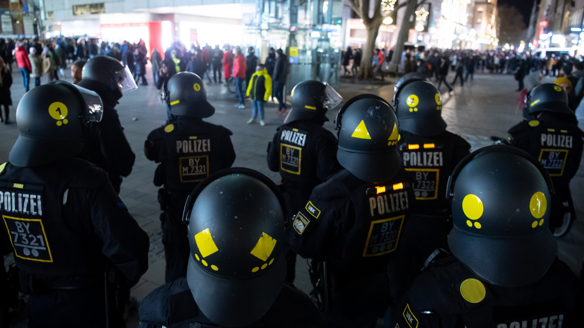 Polizisten stehen auf dem Münchner Marienplatz vor Protestierenden gegen die Corona-Maßnahmen. | dpa