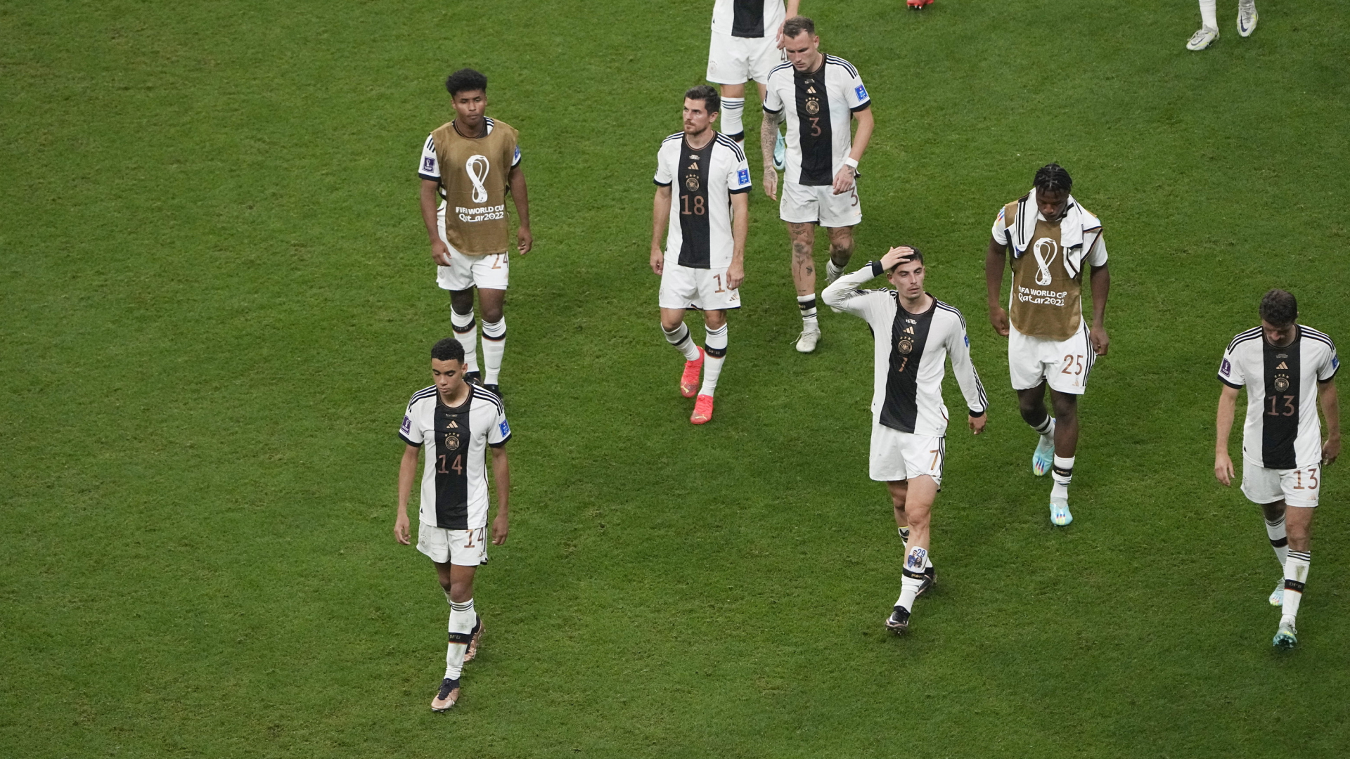 Spieler der deutschen Nationalmannschaft verlassen bei der Weltmeisterschaft in Kater niedergeschlagen den Platz. | AP