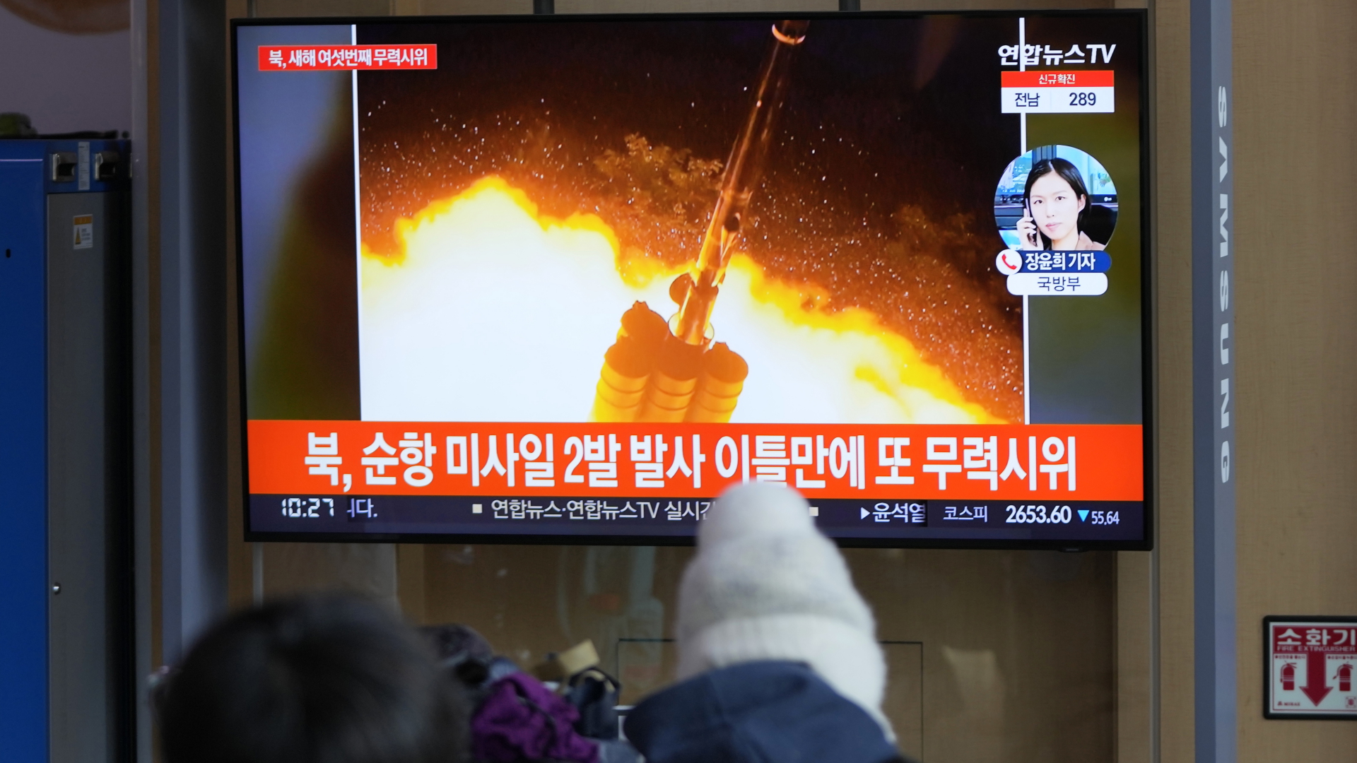 Menschen schauen auf einen Fernsehbildschirm, auf dem eine Nachrichtensendung über den nordkoreanischen Raketenstart gezeigt wird | dpa
