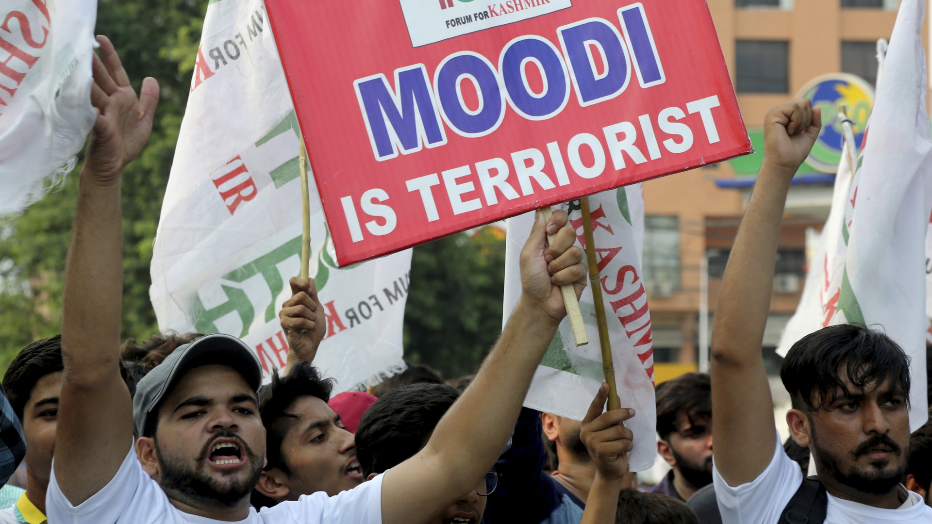 Ein pakistanischer Demonstrant hält bei einer Kundgebung ein Schild mit der Aufschrift «Moodi is Terriorist» in die Höhe. | dpa