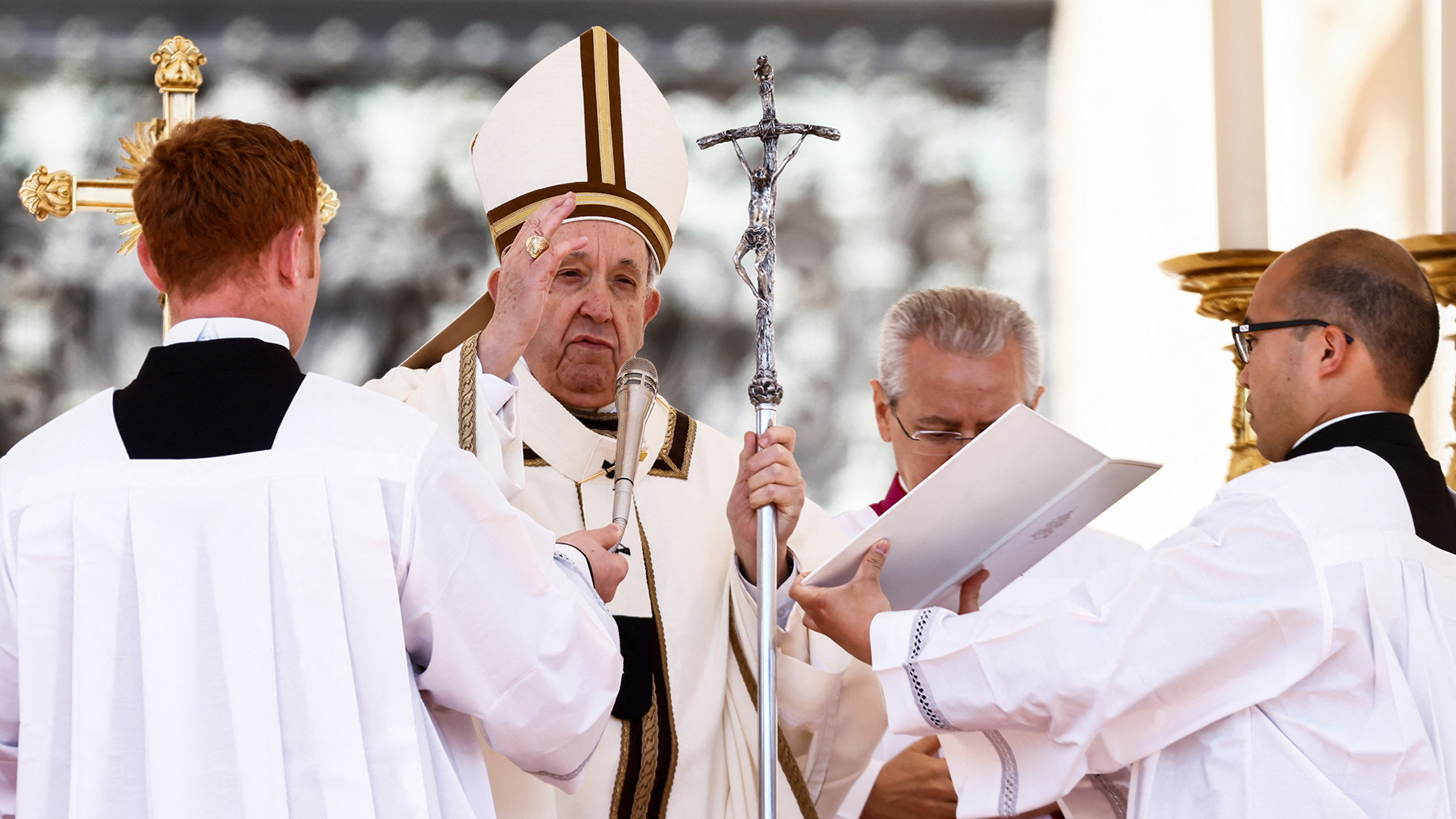  Papst Franziskus steht inmitten von Männern, die ihn unterstützen. | REUTERS