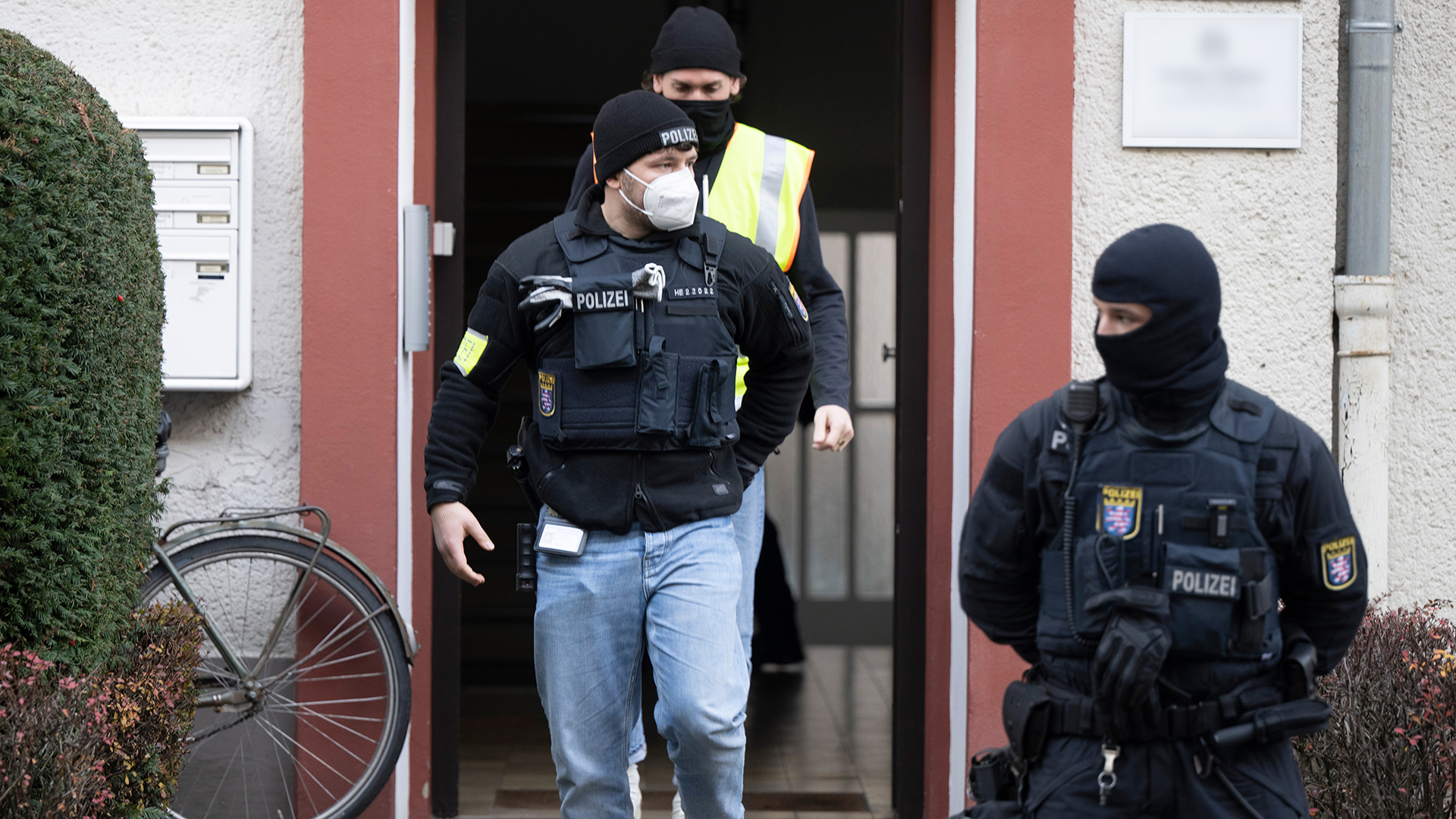 Bei einer Razzia gegen sogenannte Reichsbürger stehen Polizisten an einem durchsuchten Objekt in Frankfurt.