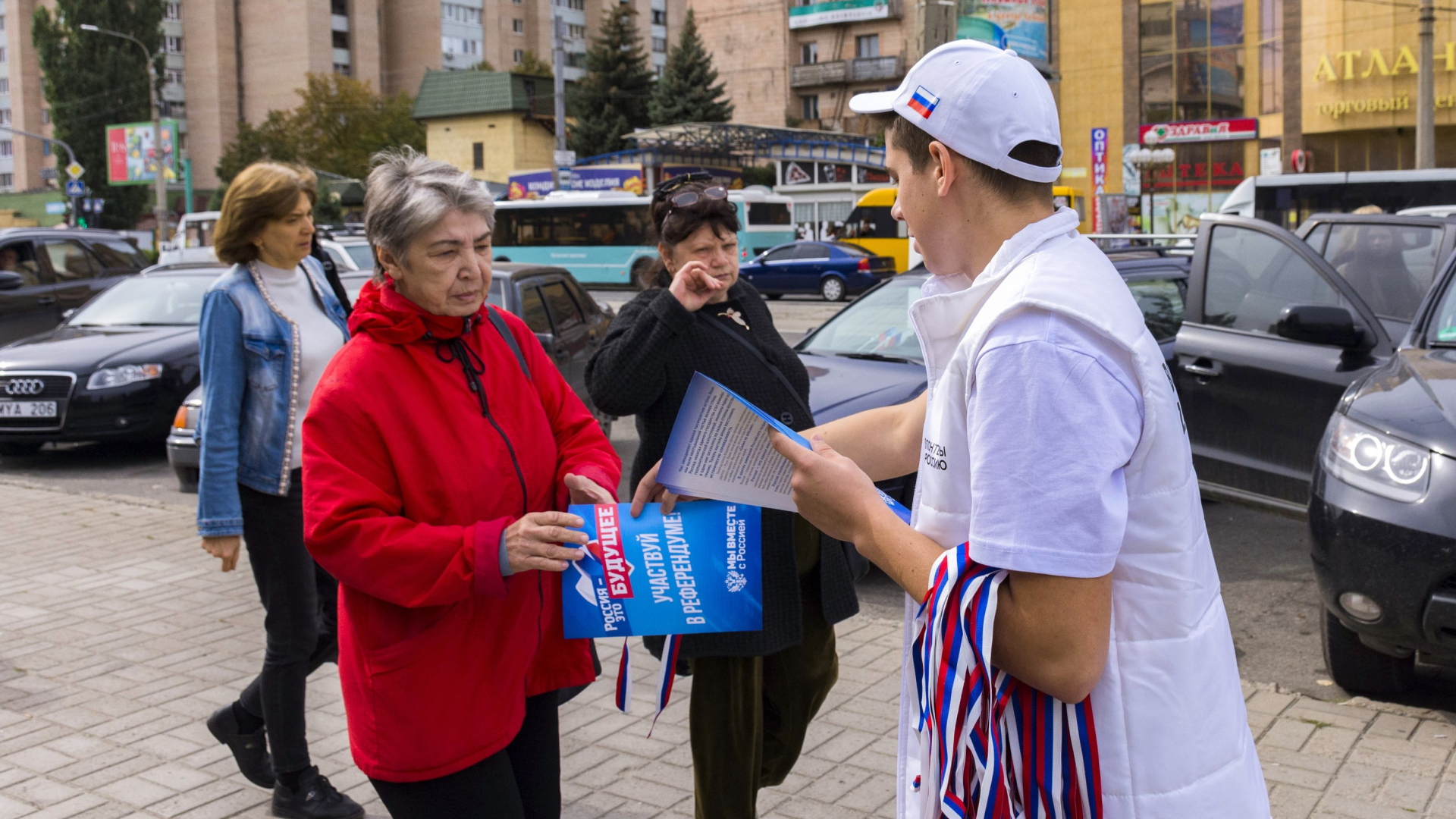 Ein Helfer verteilt in der Region Luhansk Wahlunterlagen für das sogenannte Referendum an Passanten. | AP