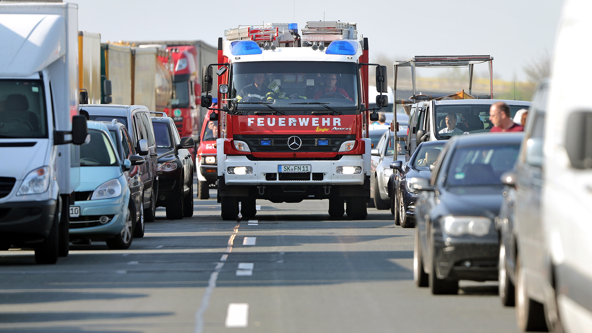 Ein Feuerwehrauto fährt durch eine Rettungsgasse. | picture alliance / Jan Woitas/dp