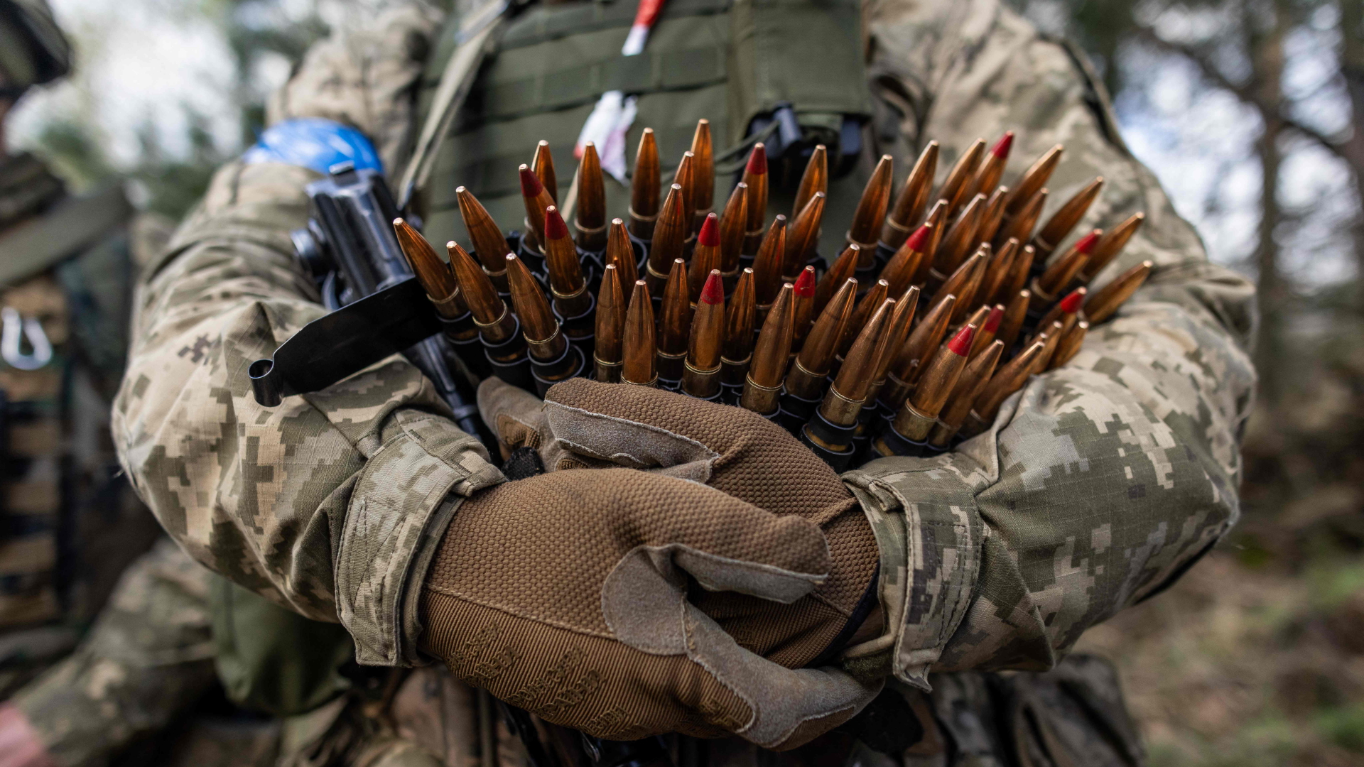 Ein ukrainischer Soldat hält Maschinengewehrmunition während einer militärischen Übung mit französischen Soldaten auf einem Truppenübungsplatz an einem ungenannten Ort in Polen.