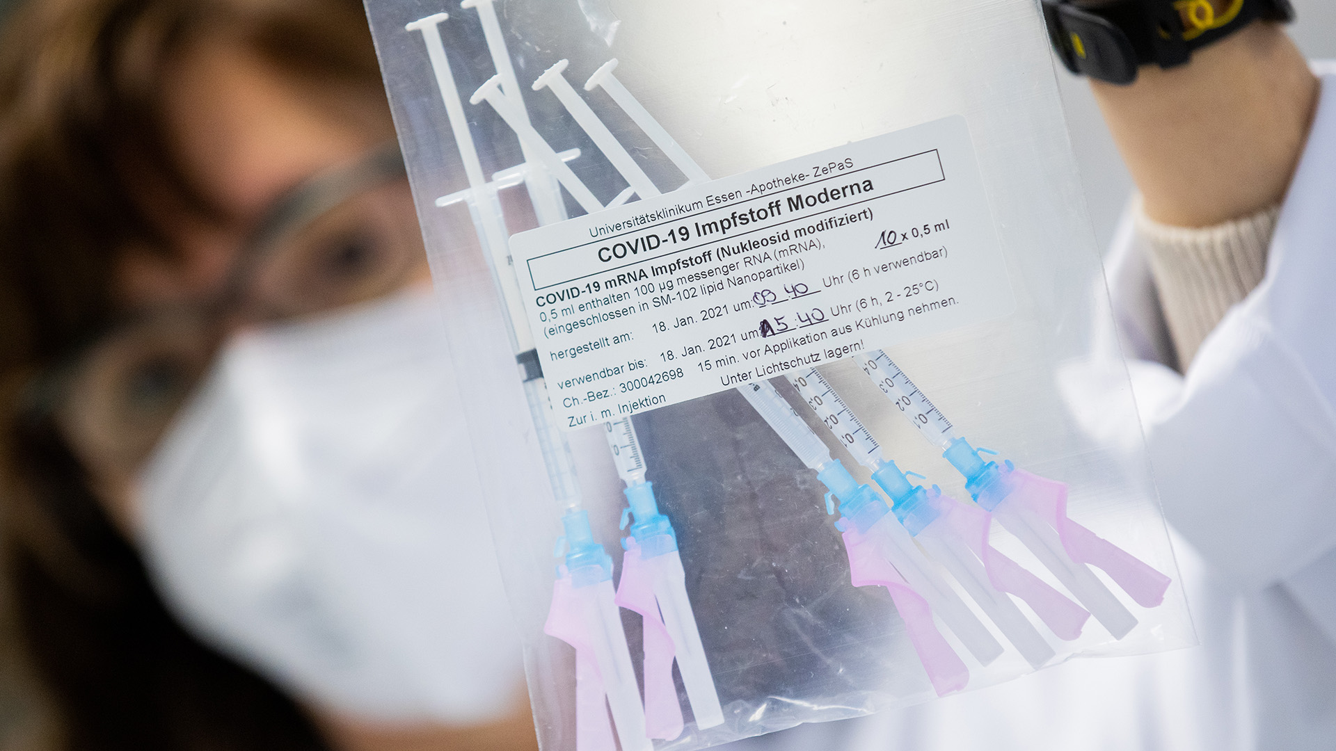 Eine medizinische Fachangestellte zeigt eine Tüte mit Spritzen, die den Impfstoff von Moderna gegen Covid-19 enthalten