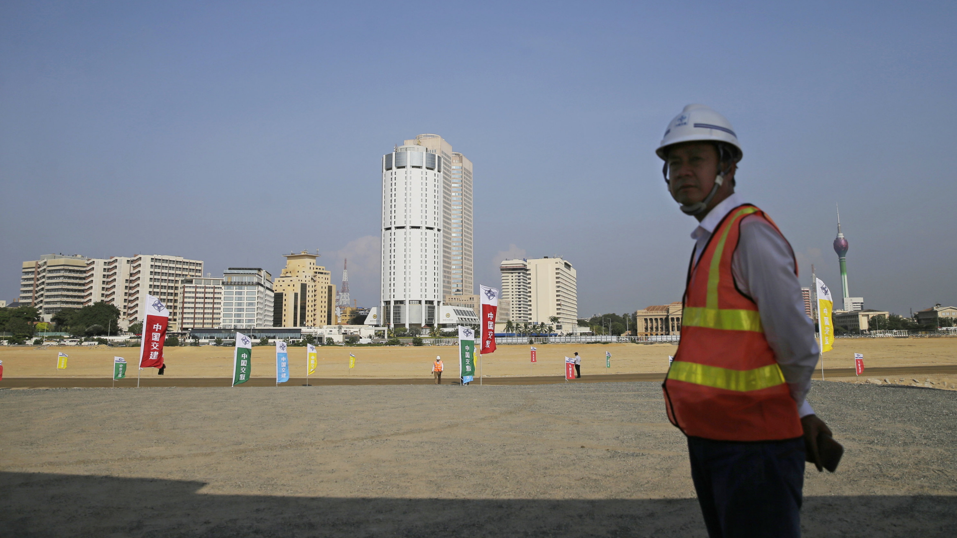 Ein chinesischer Bauarbeiter steht im Hafen von Colombo, der Hauptstadt Sri Lankas. | AP