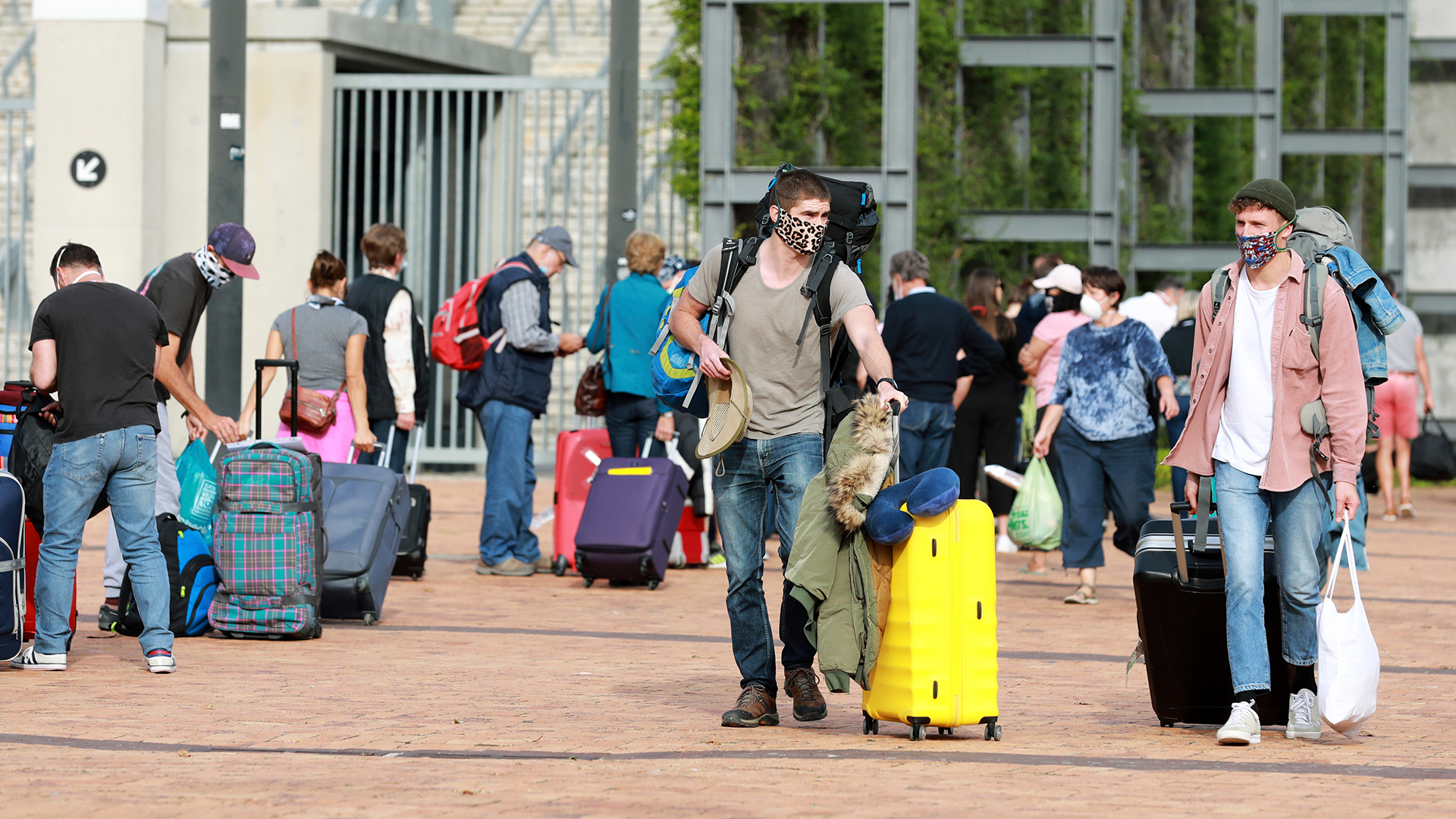 Touristen mit Gepäck am Kapstadt-Stadion, bevor sie mit einem Charterflug von Südafrika nach Deutschland reisen.  | dpa
