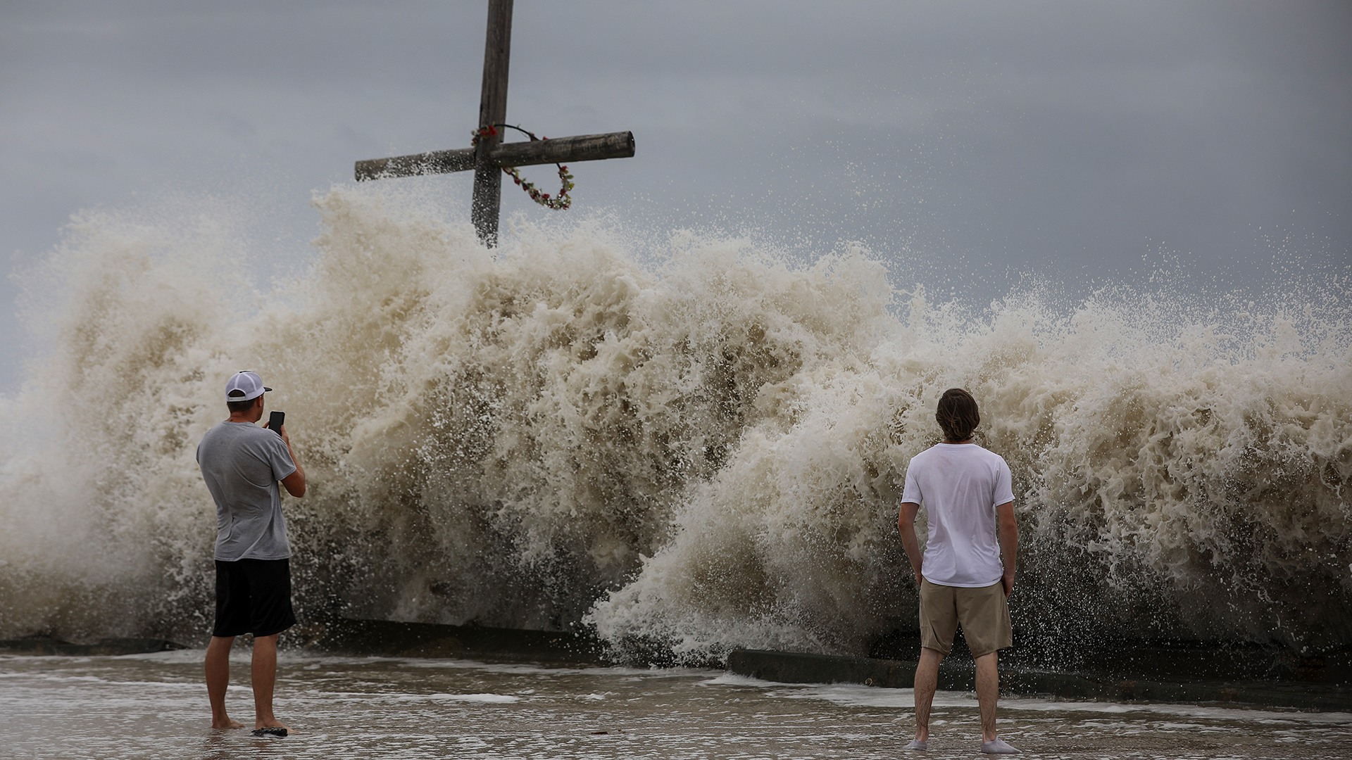 Zwei Männer betrachten die hohen Wellen, die als Vorboten von Hurrikan "Laura" auf die Küste bei High Island treffen | dpa